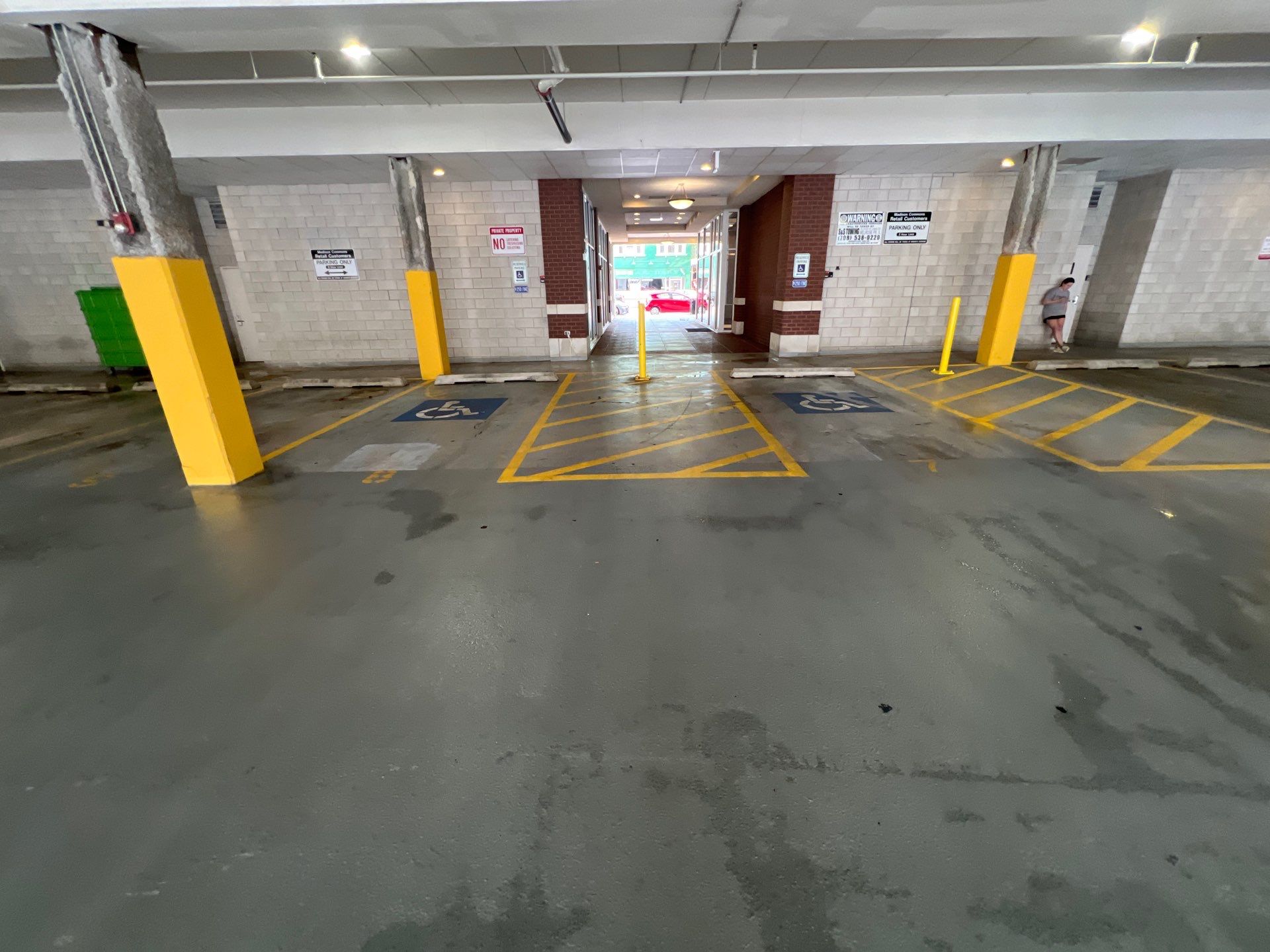 Parking garage using Hot water by Northern Power Washing LLC.