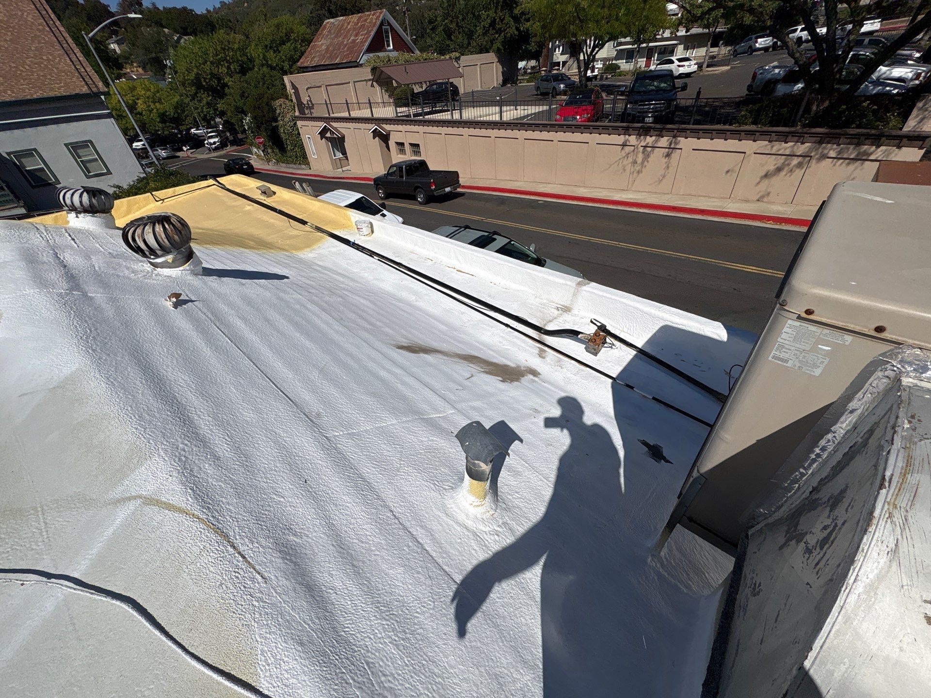 Foam and coatings on commercial roof by Straight Edge Roofing Inc