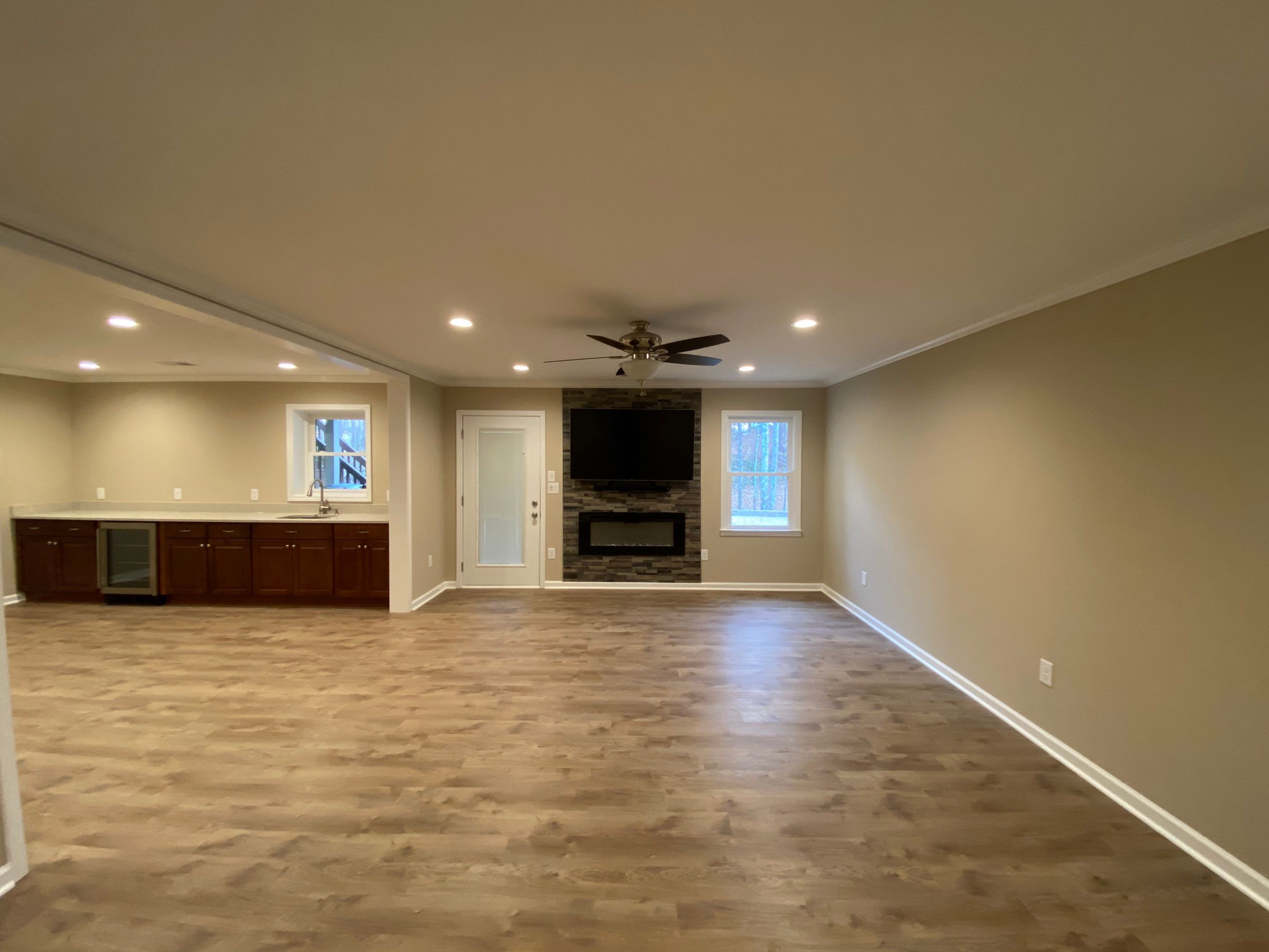 Acworth Basement Transformation With Wet Bar and Stone Fireplace by Swift Home Renovations
