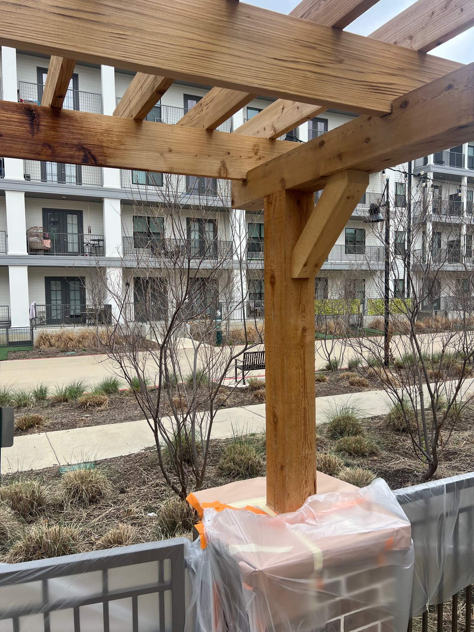 Arbor with Wrought Iron Fencing by 3:16 Roofing and Construction