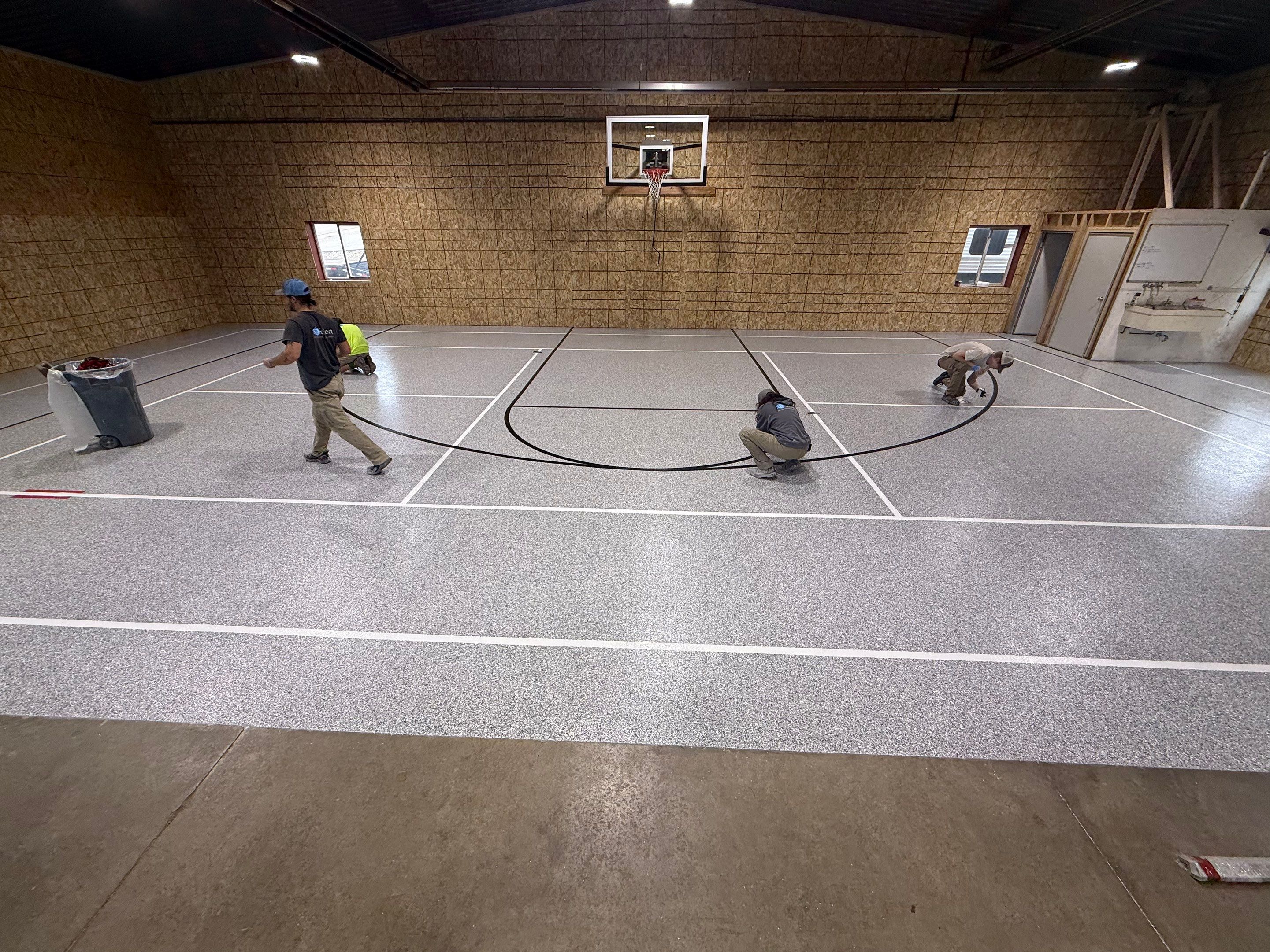 Custom Polyurea Shop Floor with Basketball Court Lines in Rock Valley by Select Painting, Coatings & Garage Cabinets