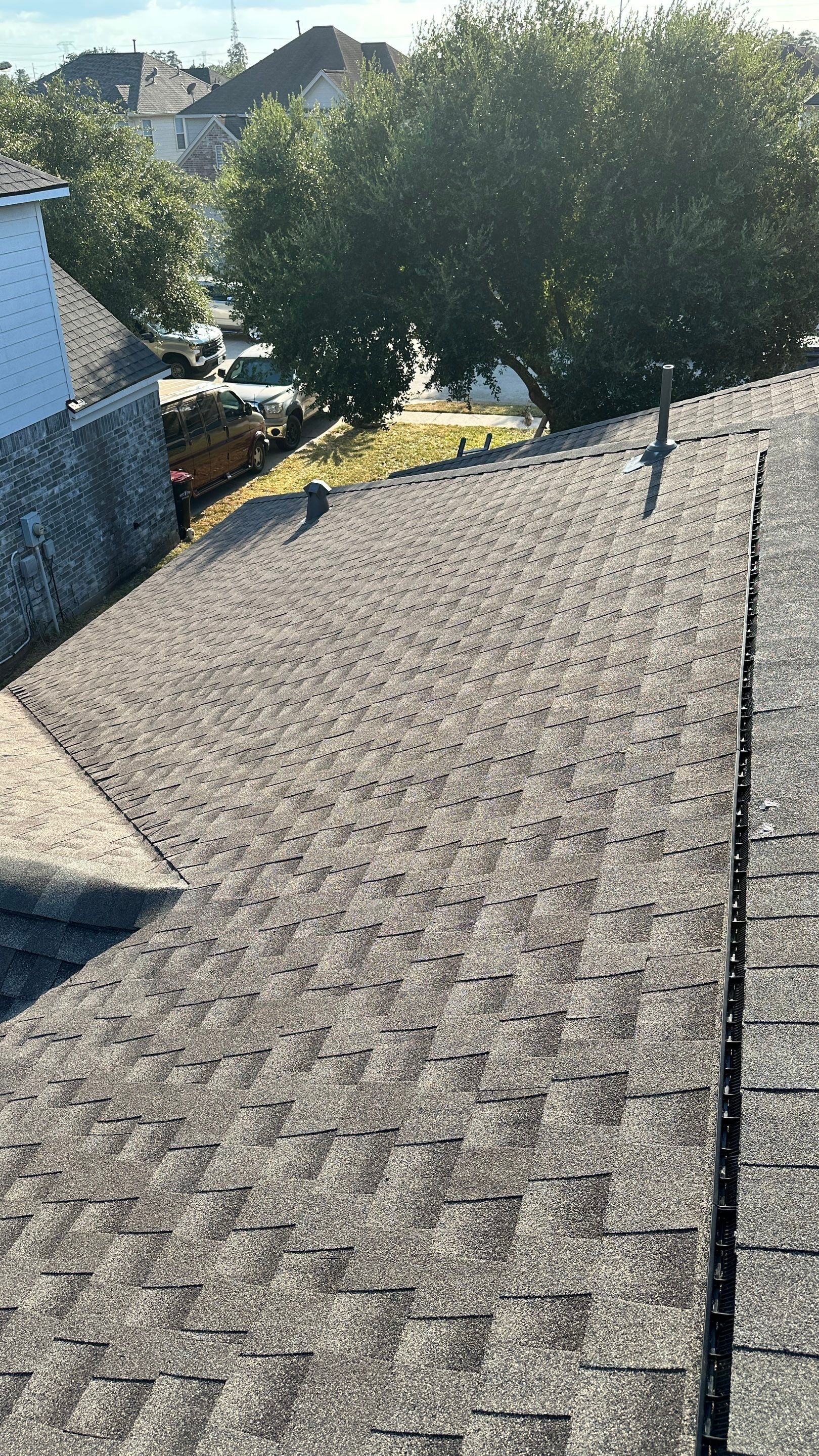 Full Roof Replacement on Two-Story Brick Home — Spring, TX by PL Roofing & SB Roofing, LLC.