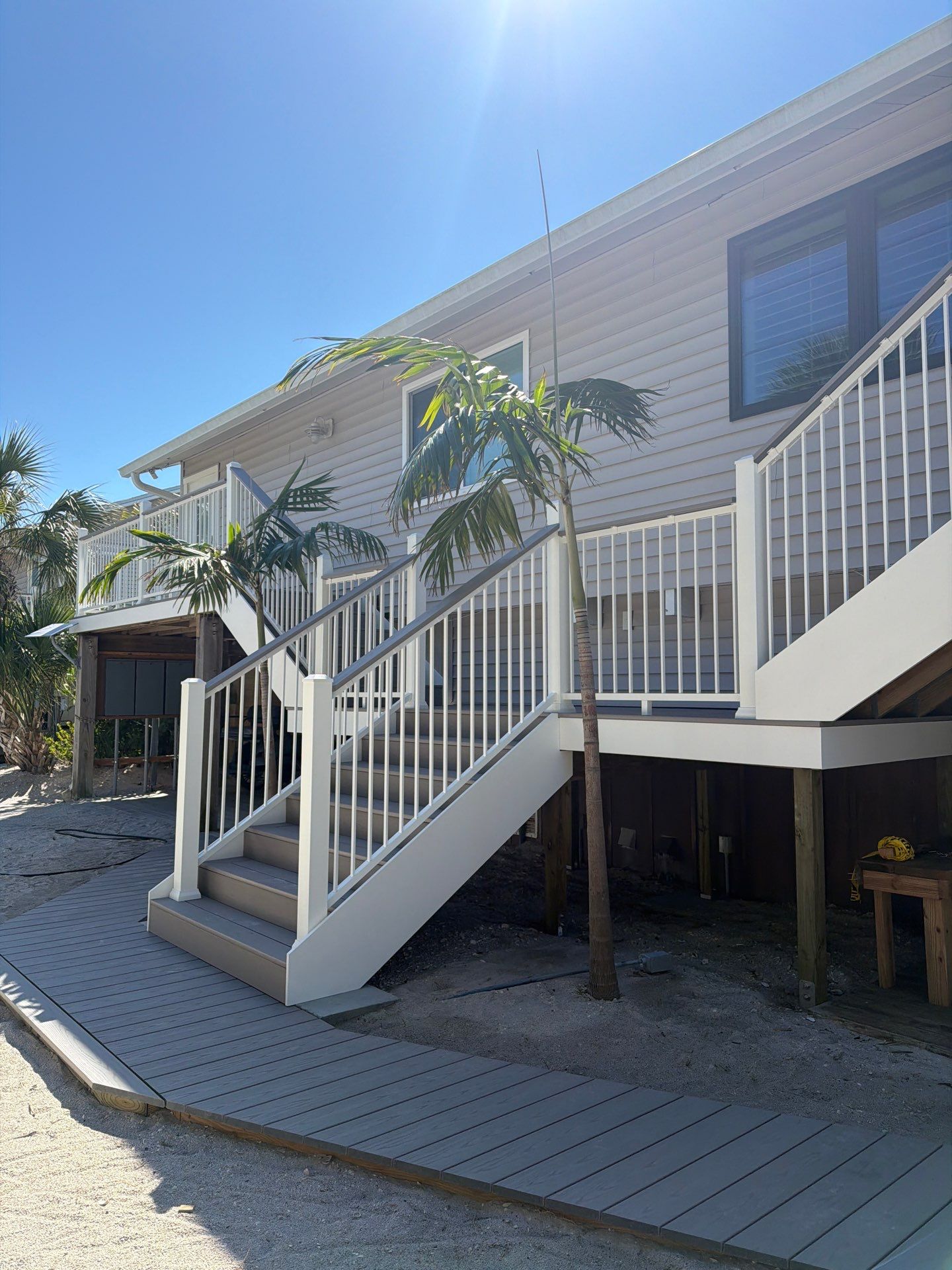 Elevated Home Deck Reconstruction With White Aluminum Railings in Placida by Smirnov Construction Inc