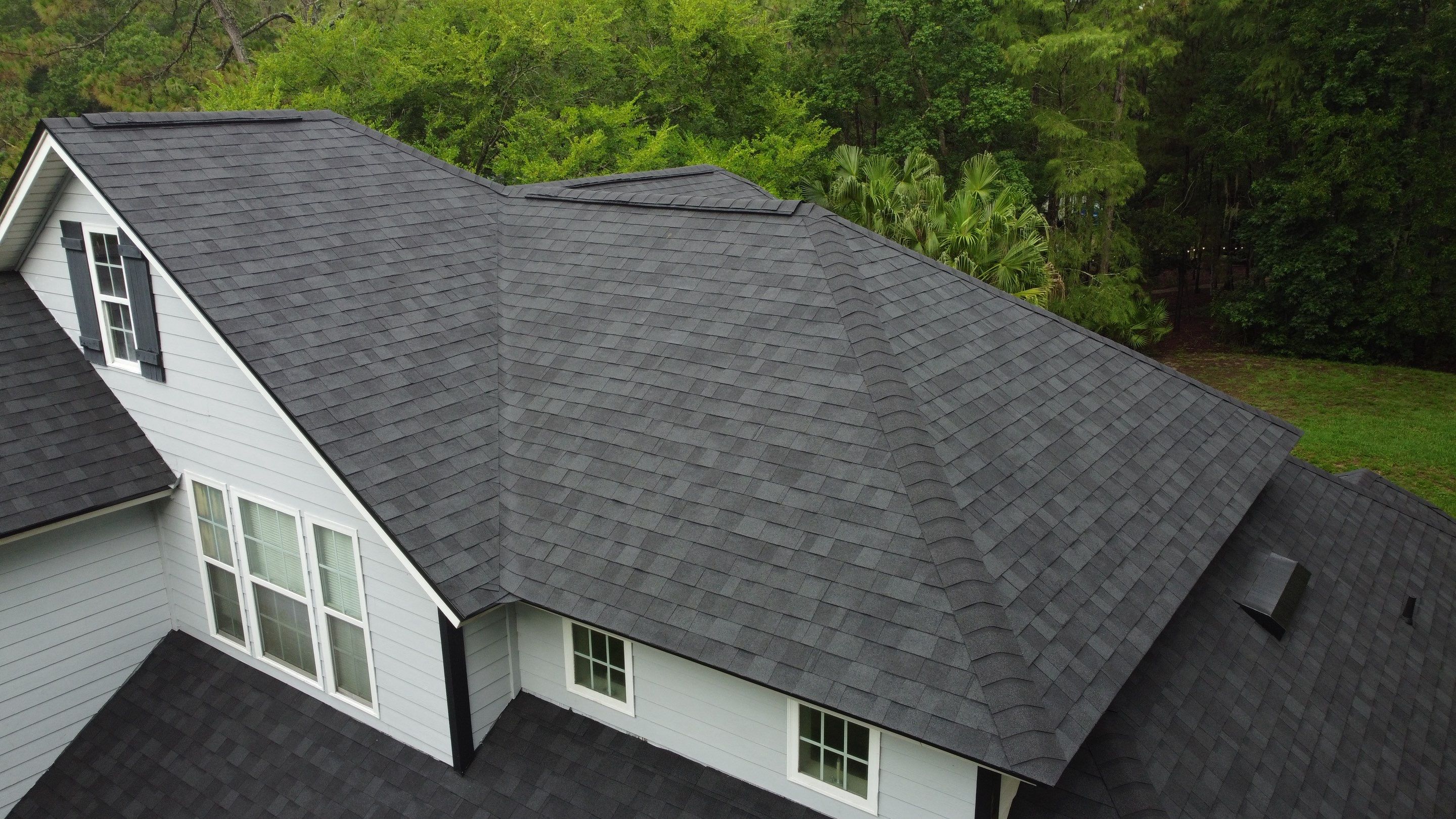 Complete Onyx Black Asphalt Shingle Roof Replacement and Skylight Installation in Jacksonville by Trinity Restoration and Roofing LLC
