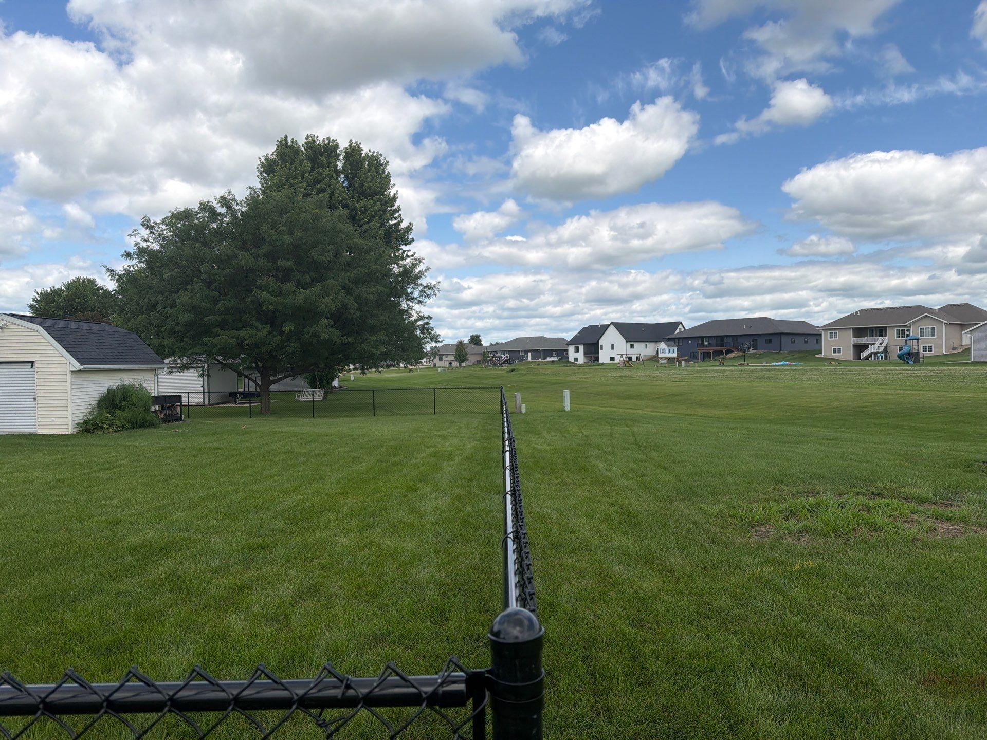 Black Vinyl-Coated Chain Link Fence Installation in Fairbank by Perfect Picket Fence and Stain