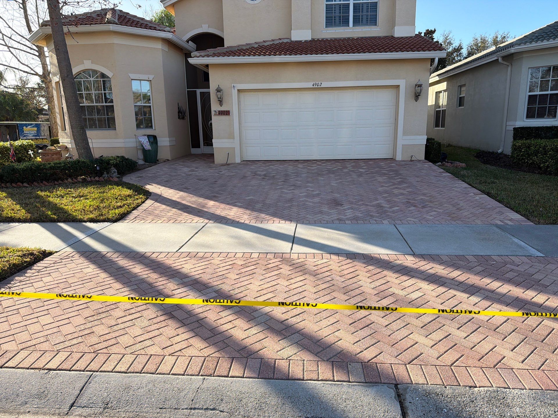 Paver Sealing for Herringbone Driveway and Screened Lanai in Valencia Lakes by Supreme Paver Experts