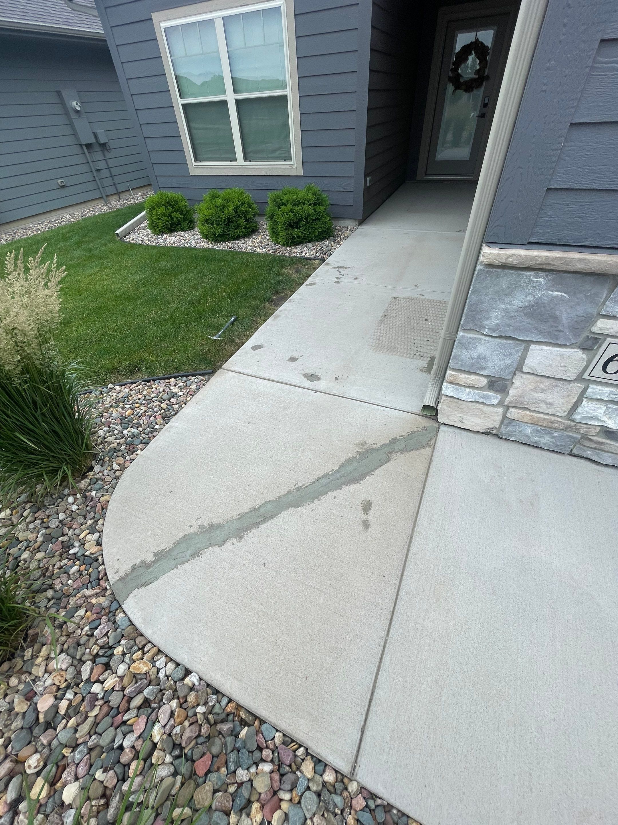Textured Concrete Patio Coating and Custom Privacy Pergola in Sioux Falls by Select Painting, Coatings & Garage Cabinets
