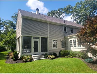 Wood Clapboards and vinyl Slate roof with new Pella windows in Wellesley.