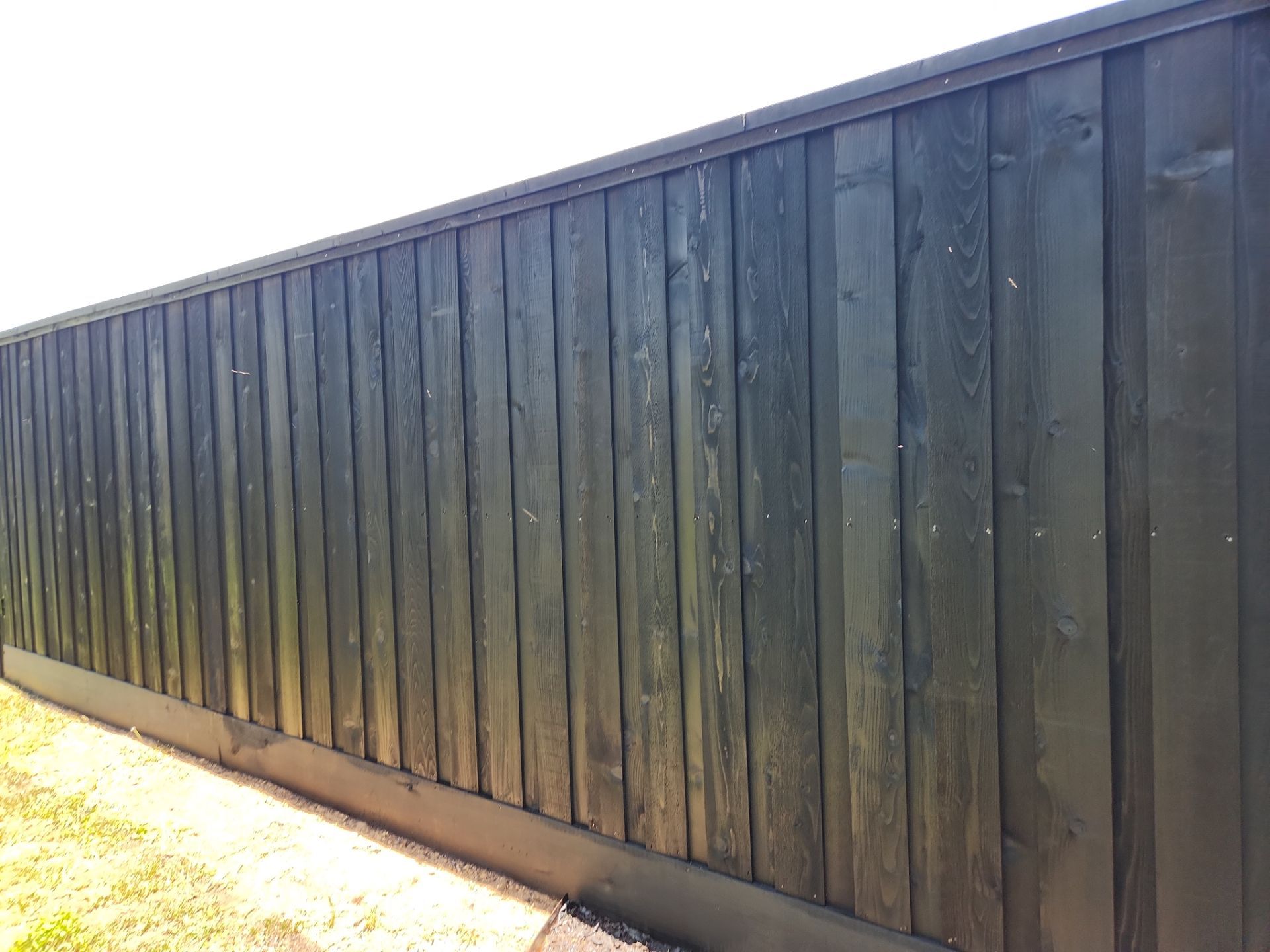 Modern Black Fence Finish by Tim's Fences