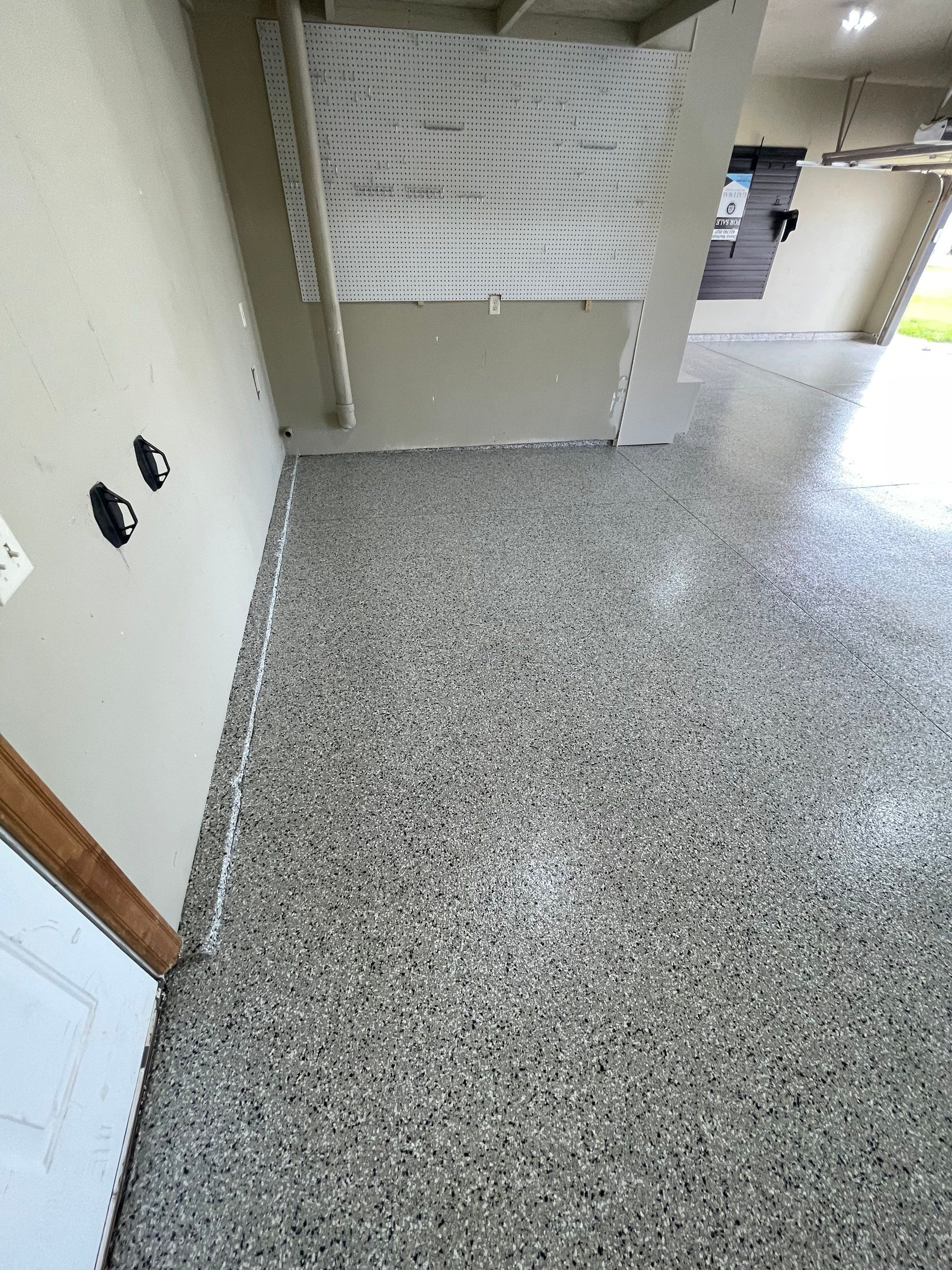 Cabin FEver Flake Garage Floor Coating Installation in Sioux Falls by Select Painting, Coatings & Garage Cabinets