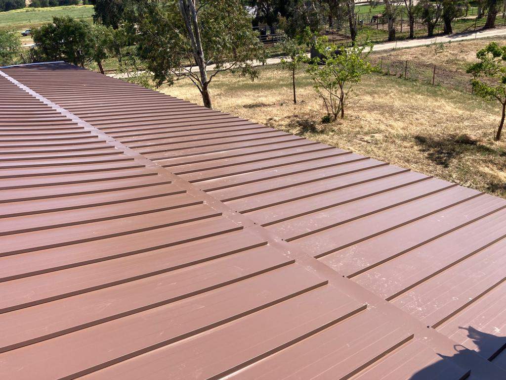 Metal roofing installation using Standing seam metal roofing system by Straight Edge Roofing Inc