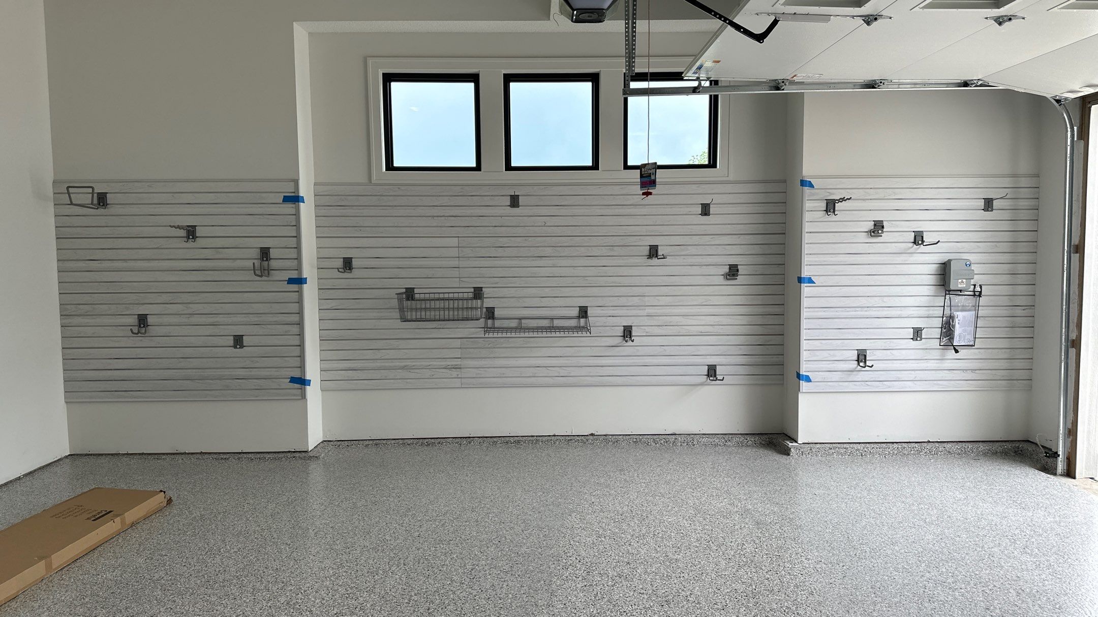 Jon S. transformed his garage with a new floor, slotwall & Cabinets! by Banner Garage