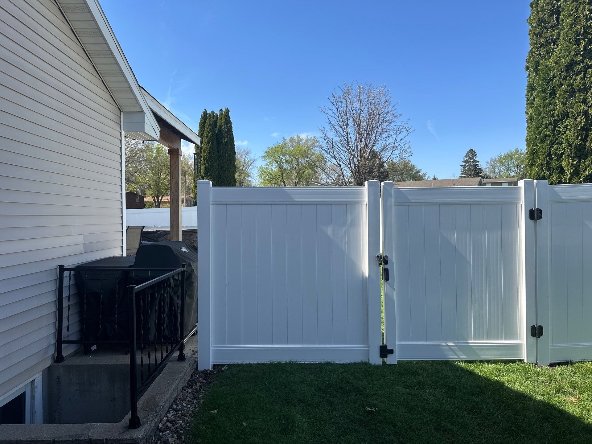 White Vinyl Privacy Fence Installation in Raymond, Iowa by Perfect Picket Fence and Stain