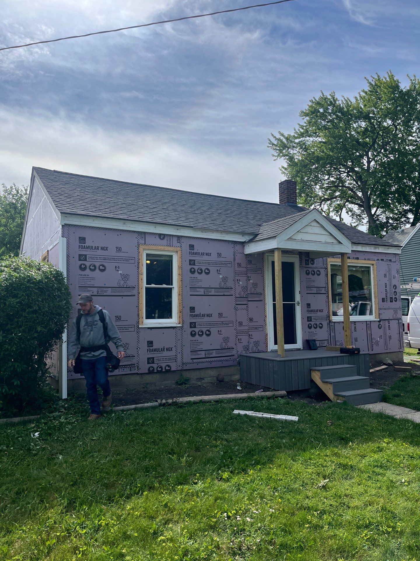 Blue Vinyl Siding and Versetta Stone Exterior Remodel in Bay City by Great Lakes Home Design LLC