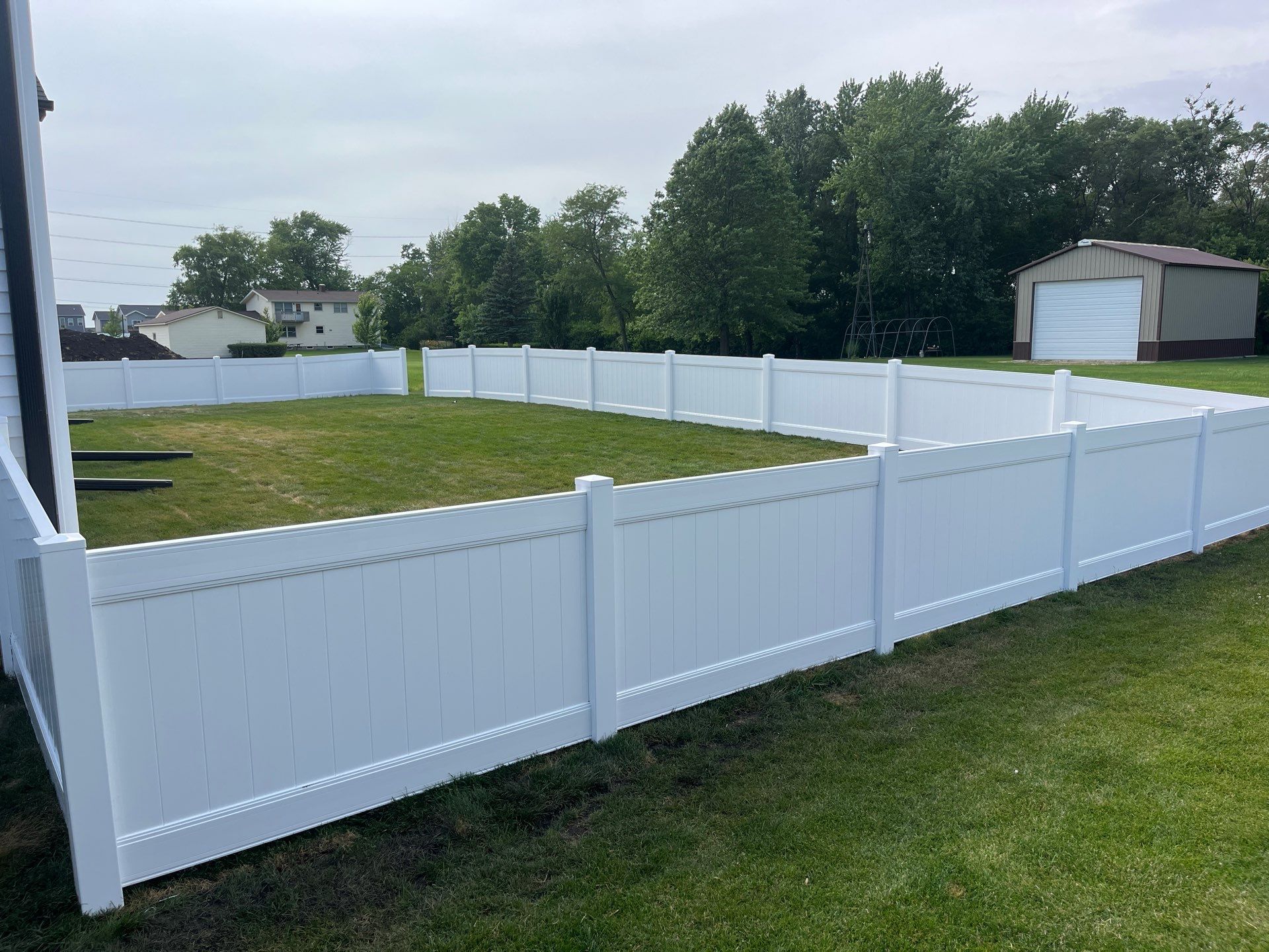 White Vinyl Privacy Fence With Pet Window in Cedar Falls by Perfect Picket Fence and Stain