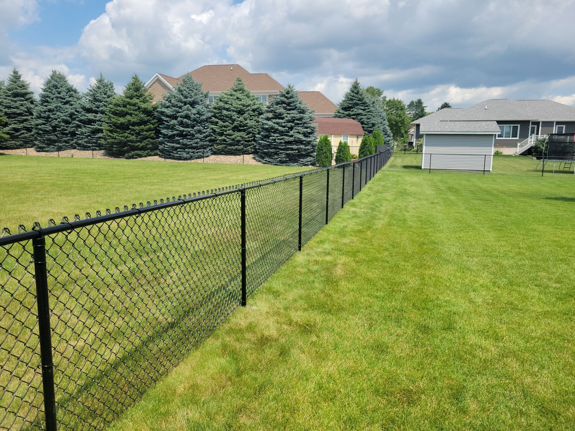 Black Vinyl Coated Chain Link Fence Installation in Cedar Falls by Perfect Picket Fence and Stain