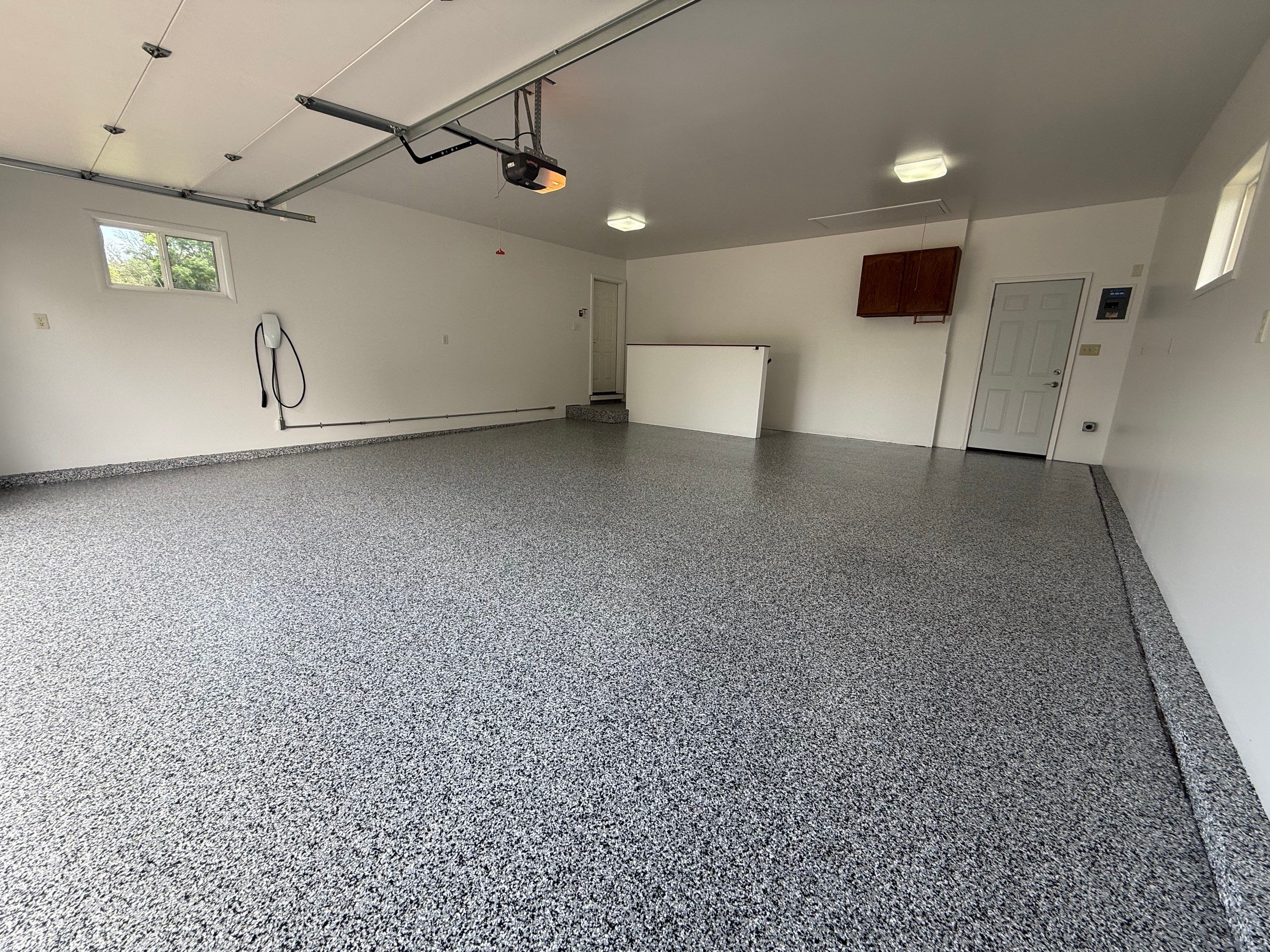 Full Garage Floor and Basement Stair Epoxy Coating in Sioux Falls by Select Painting, Coatings & Garage Cabinets
