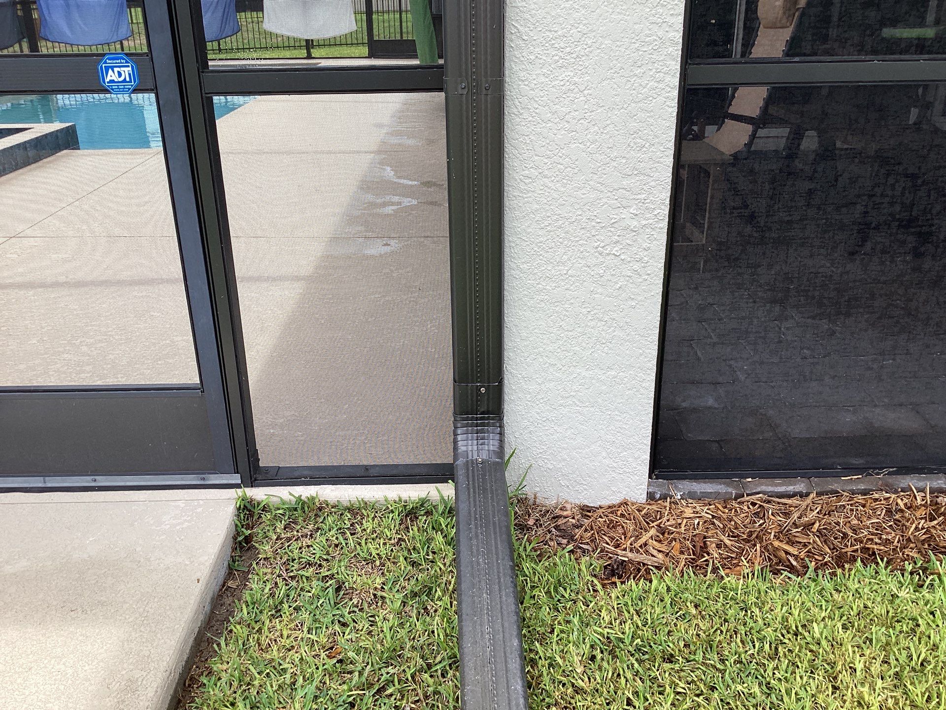 Musket brown seamless gutters with splash guards, new downspouts, and extensions in Bradenton, FL by Gutter Professors