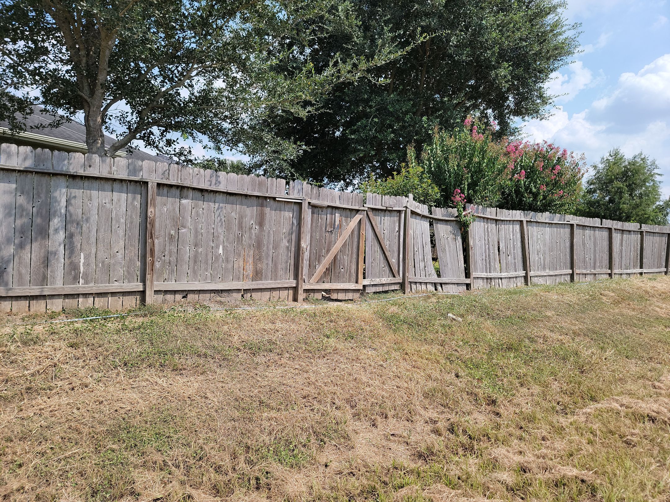 Beautiful Wood fence with metal posts by Tim's Fences