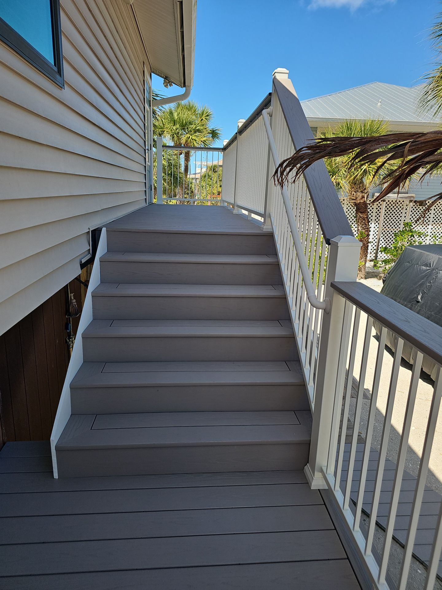 Elevated Home Deck Reconstruction With White Aluminum Railings in Placida by Smirnov Construction Inc