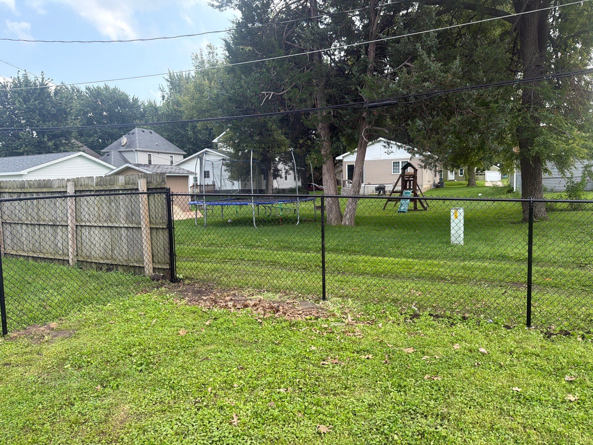 Residential Black Chain Link Fence Installation in Reinbeck by Perfect Picket Fence and Stain