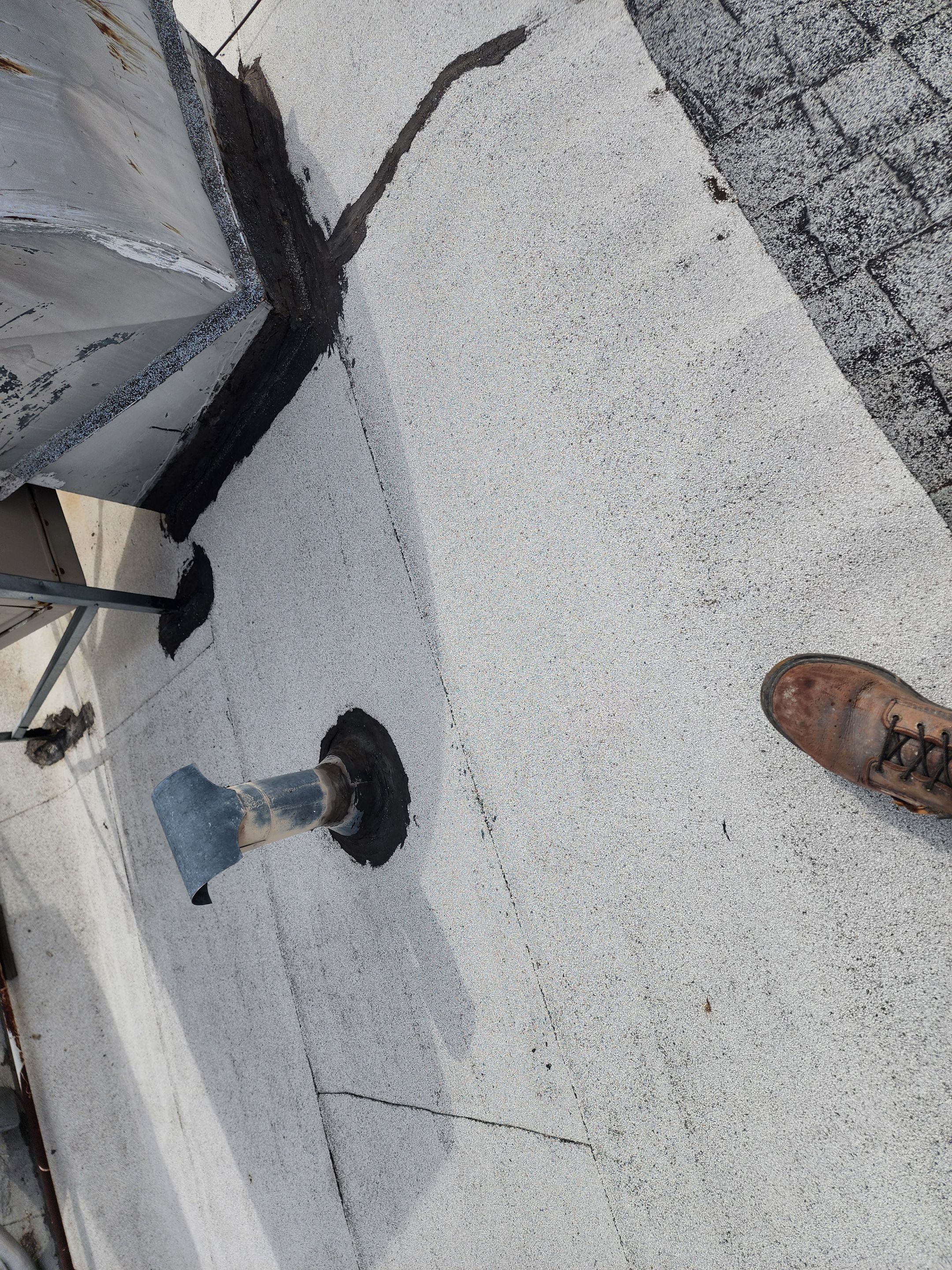 Foam and coatings on commercial roof by Straight Edge Roofing Inc