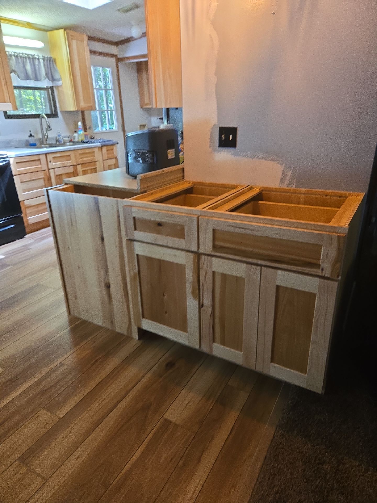 Stunning Kitchen Transformation with Raw Hickory Cabinets by A Step Above Handy LLC 