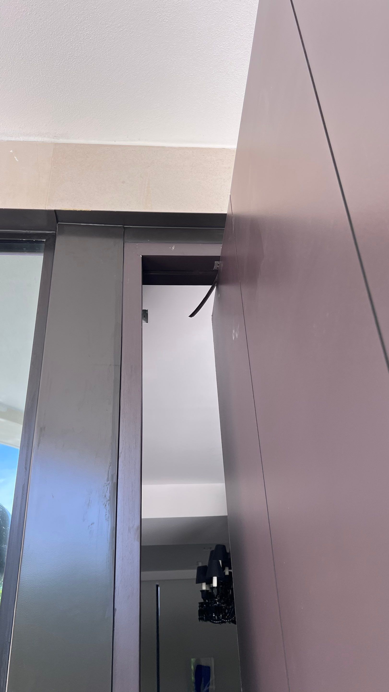 Custom Material Pivot Door installation by Impact Precious Wood Inc.