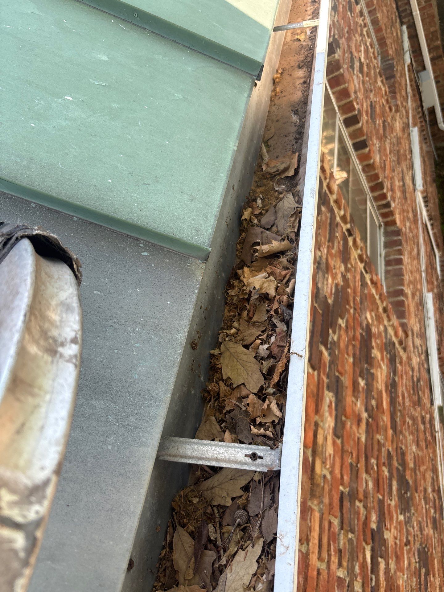 Commercial gutter cleaning Overland Park, KS before photo with filled gutters