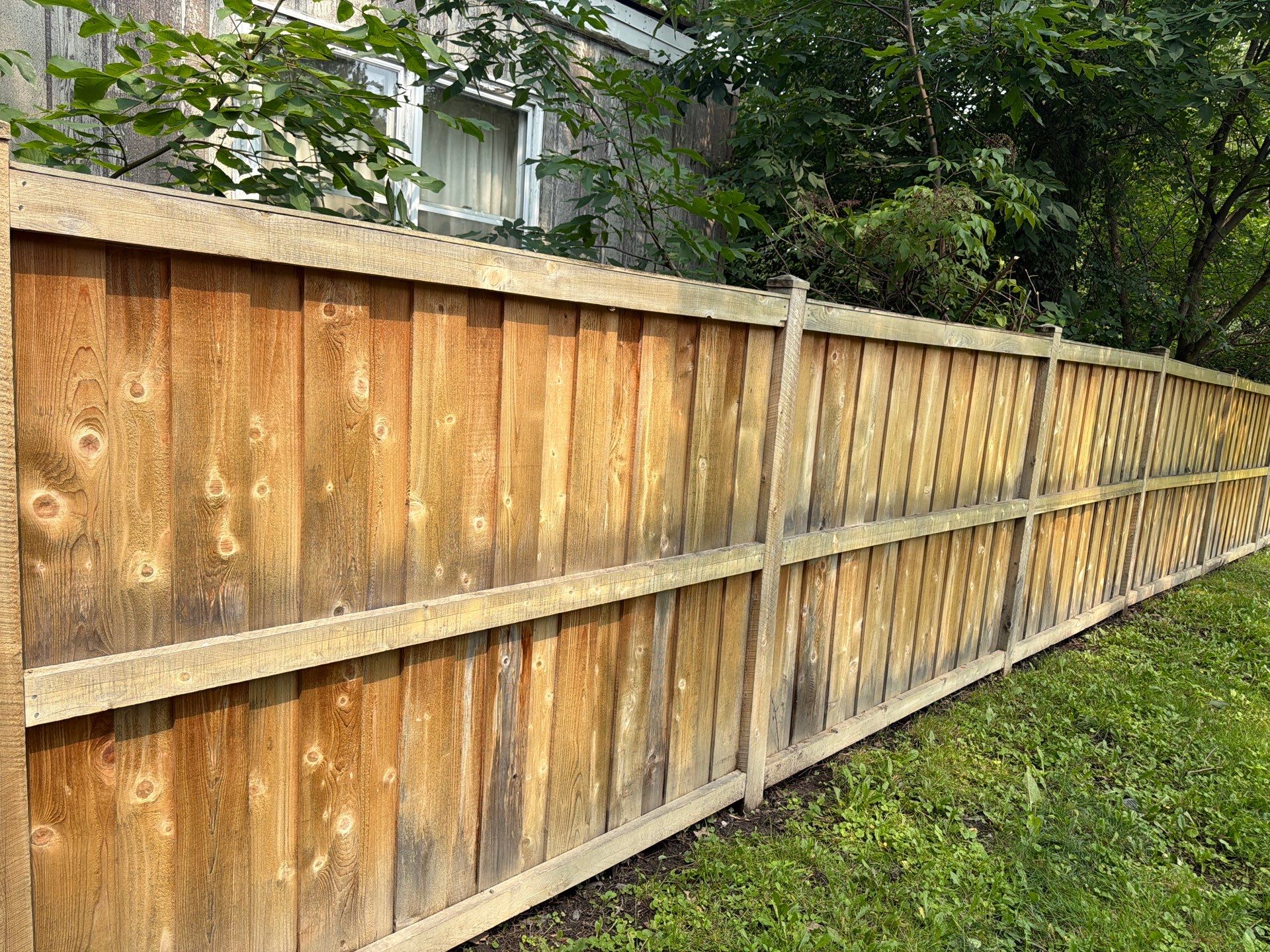 Wood fence cleaning and sealing by Northern Power Washing LLC.