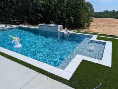 Modern Geometric Pool with Raised Spa and Turf Accents