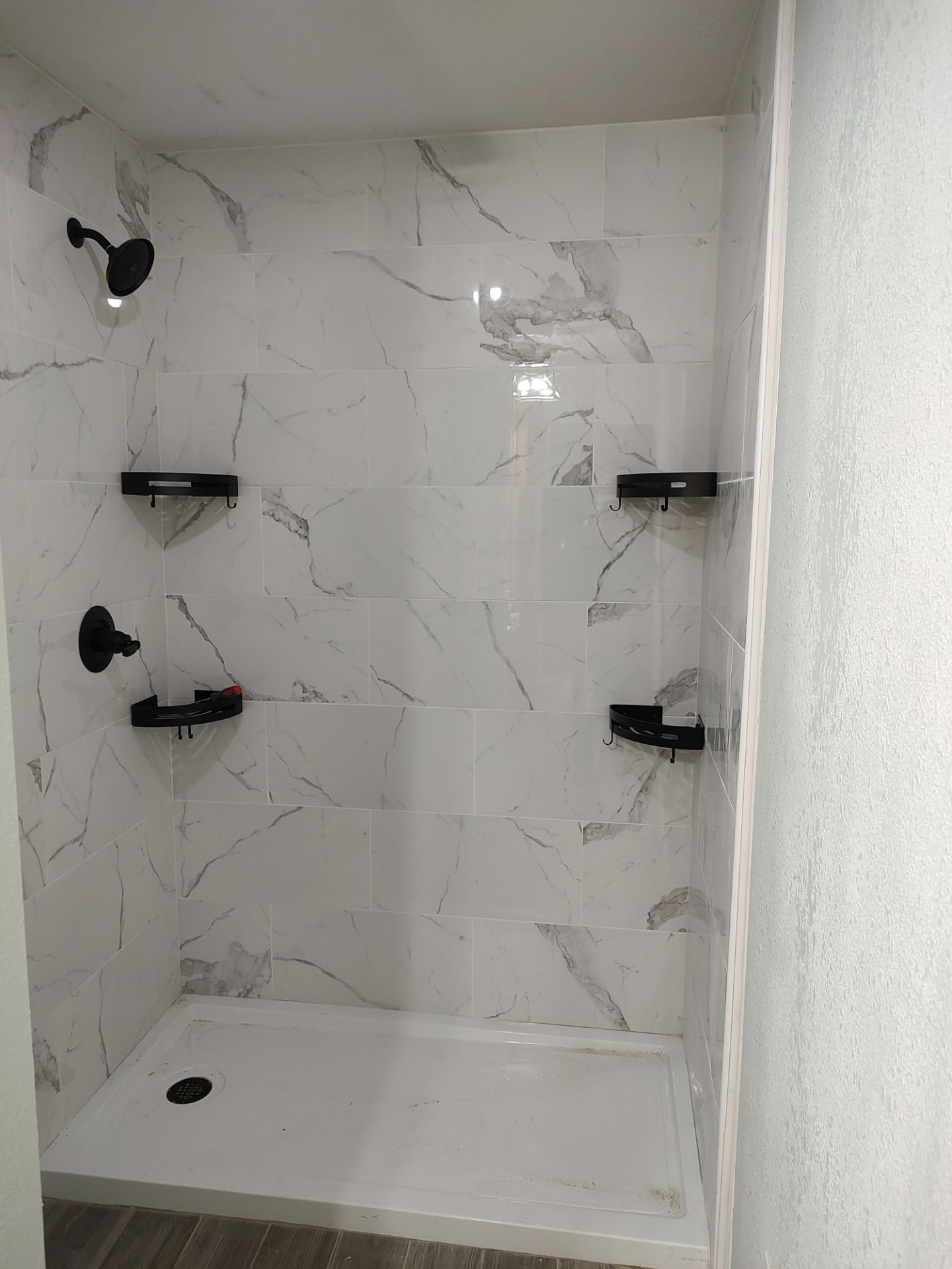 Bathroom remodel w/shower upgrade by In & Out Construction & Remodeling, LLC