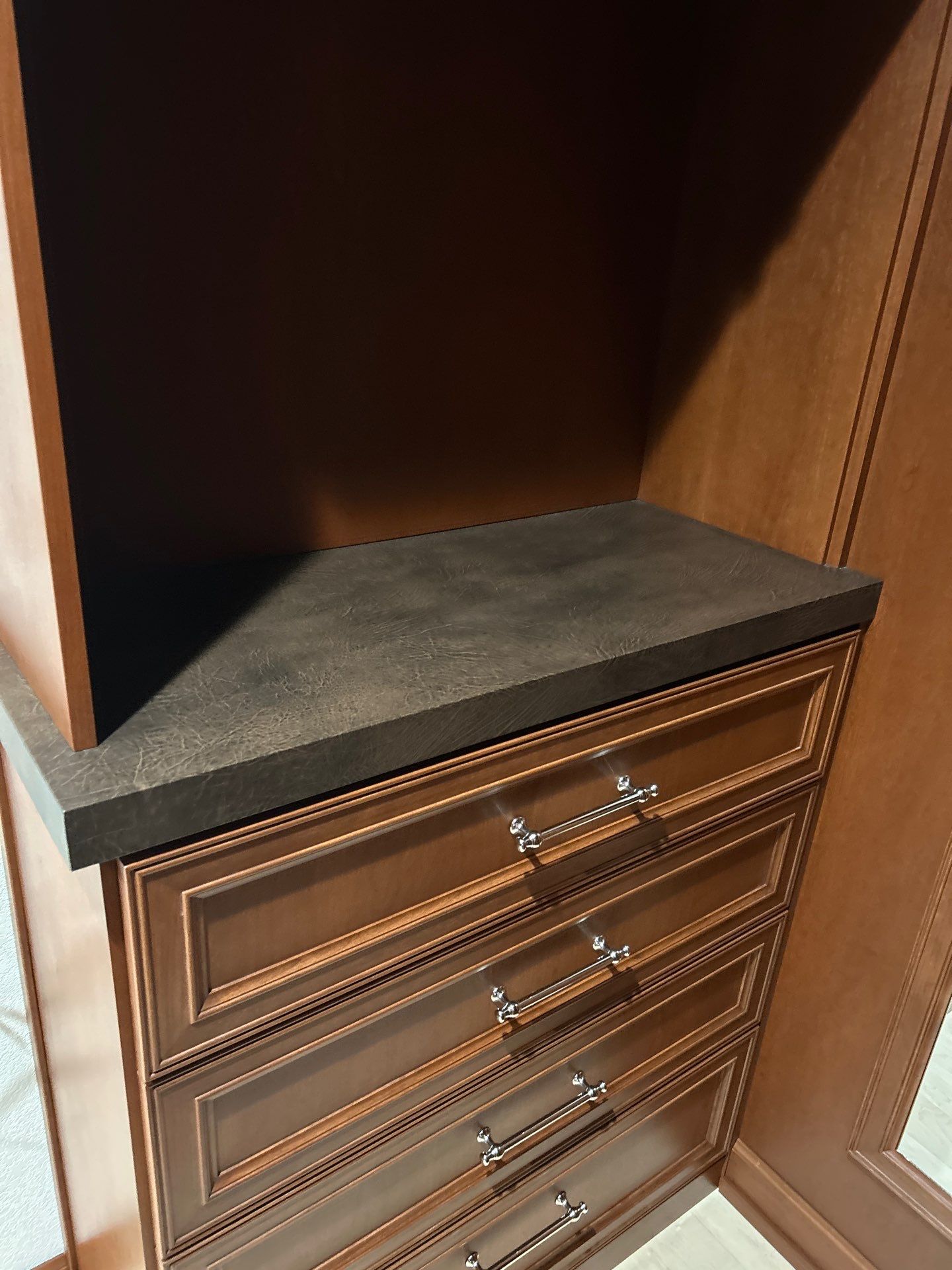 Stained Cherry Wood Primary Closet by Concept 32, Inc.