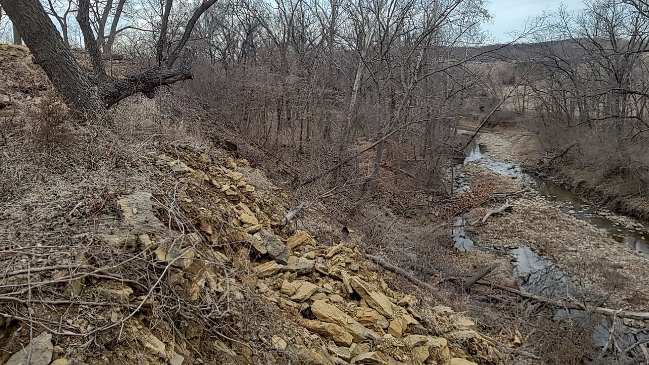 Supporting back of home with backfill at edge of steep creek by LAND ESCAPES LLC