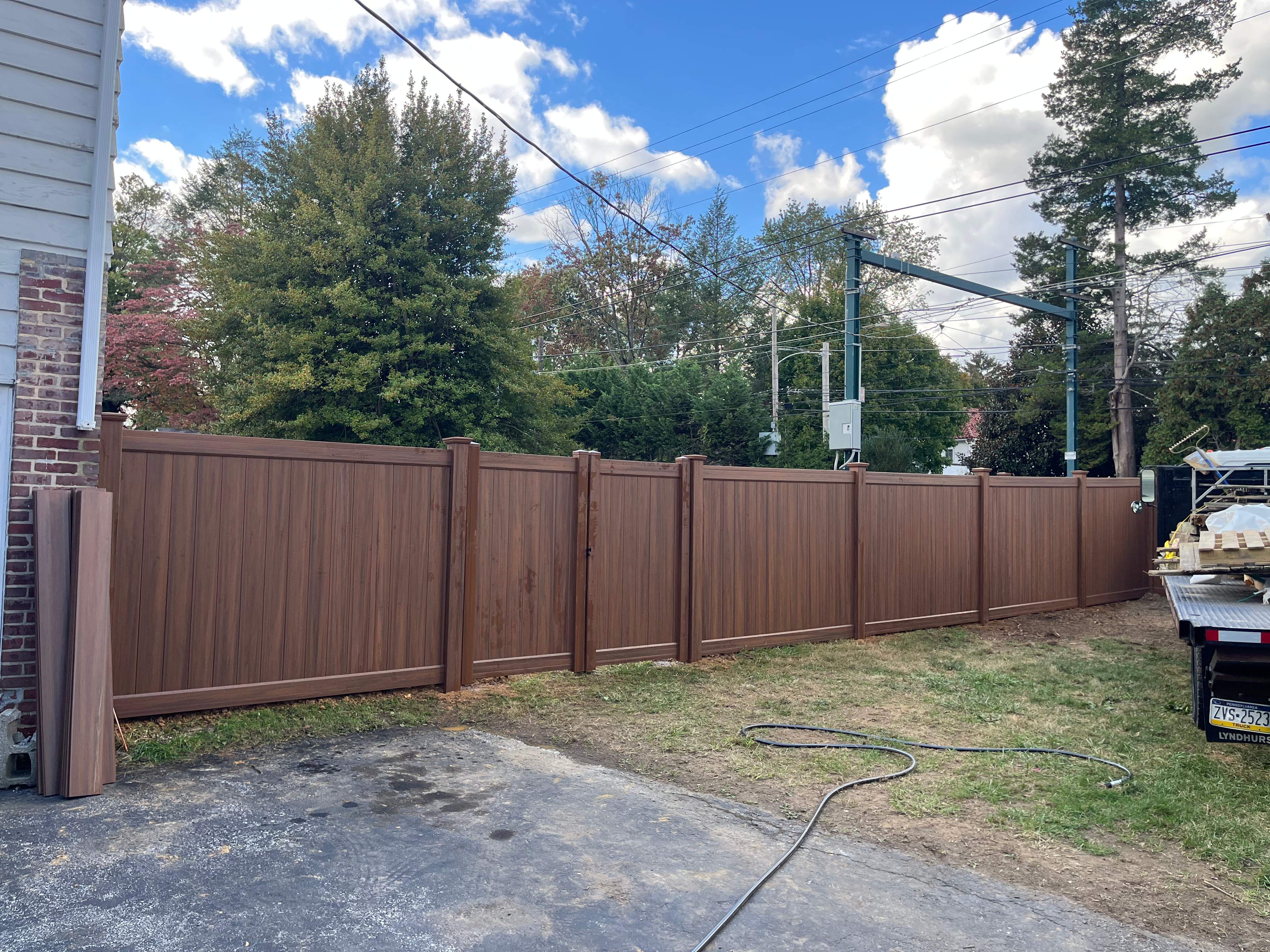 6' High Mocha Walnut Vinyl Installation by Jensen Fencing