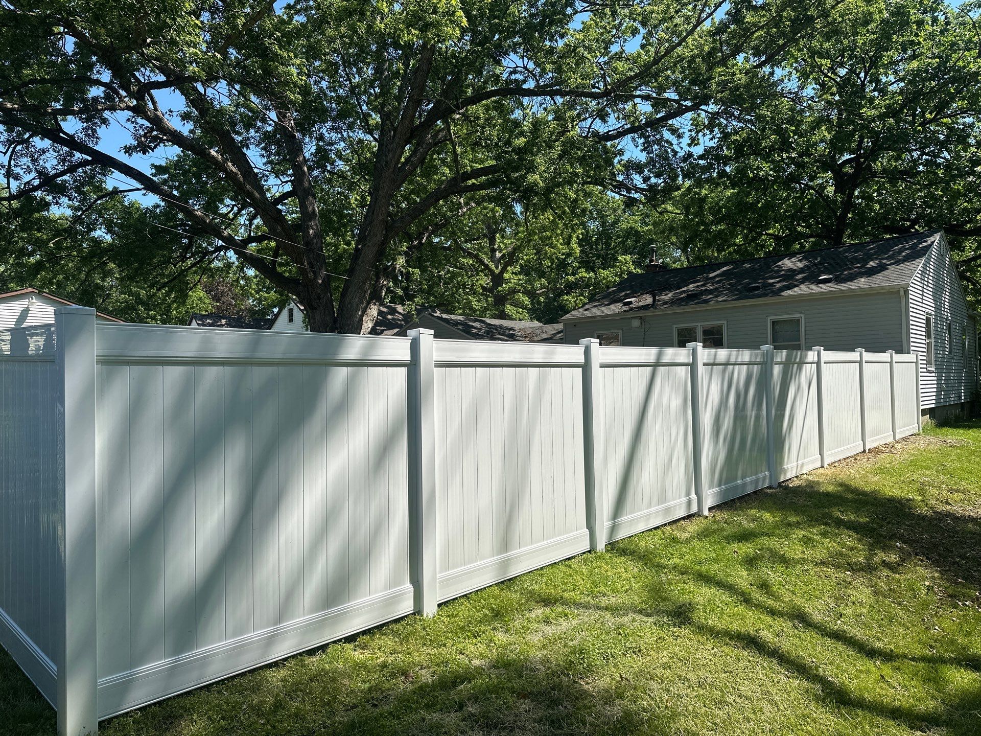 White Vinyl Privacy Fence and Double Gate Installation in Cedar Falls by Perfect Picket Fence and Stain
