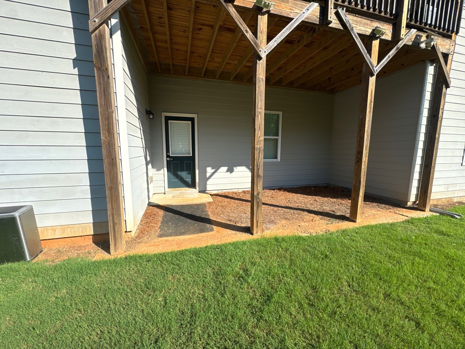 Ground-Level Gray Composite Deck and Privacy Fence Installation by Swift Home Renovations