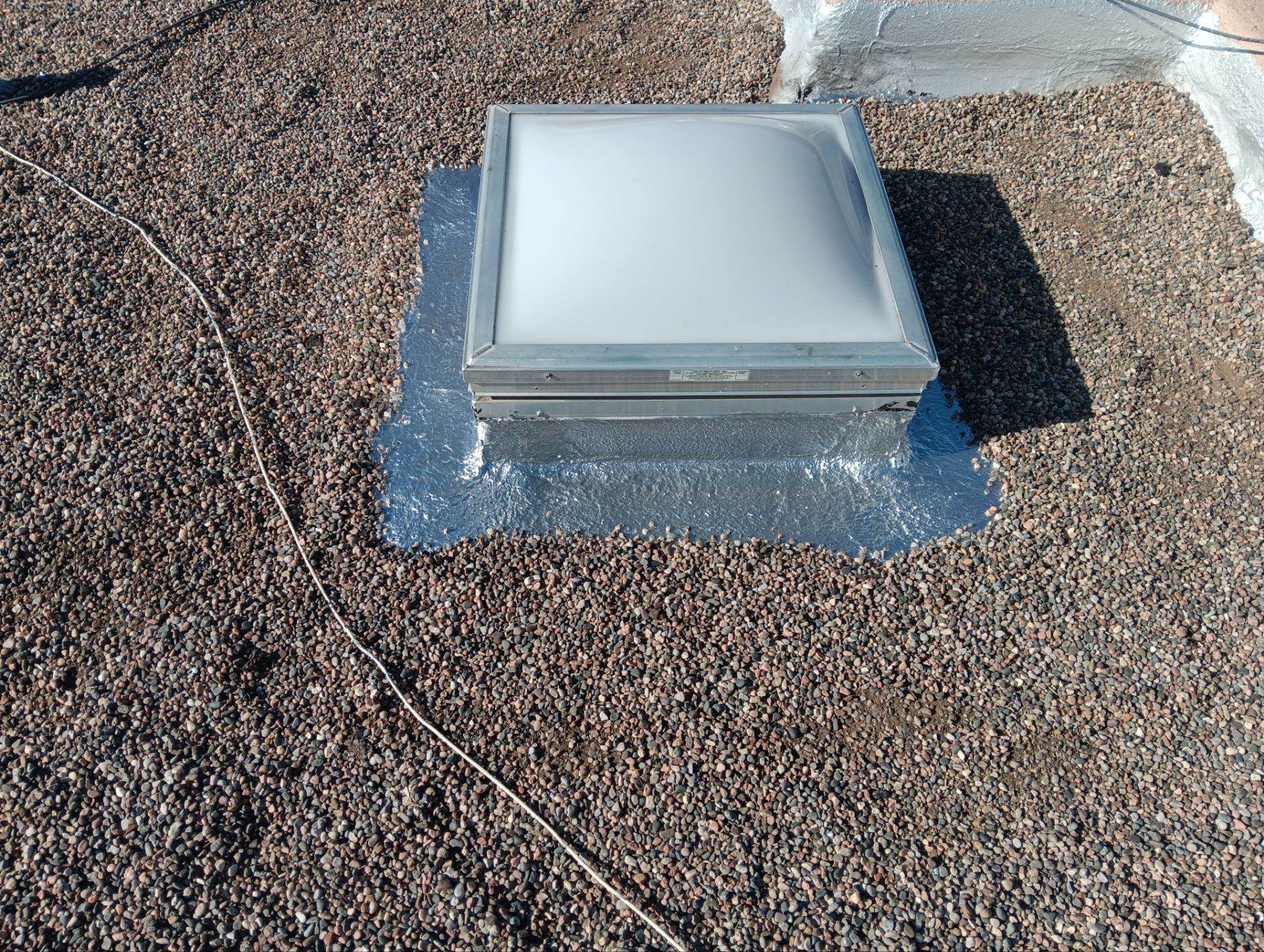 Roof Maintenance and Low-E Tempered Glass Skylight Replacement on Gravel Roof in Northwest Albuquerque by Doyle Roof Masters Inc