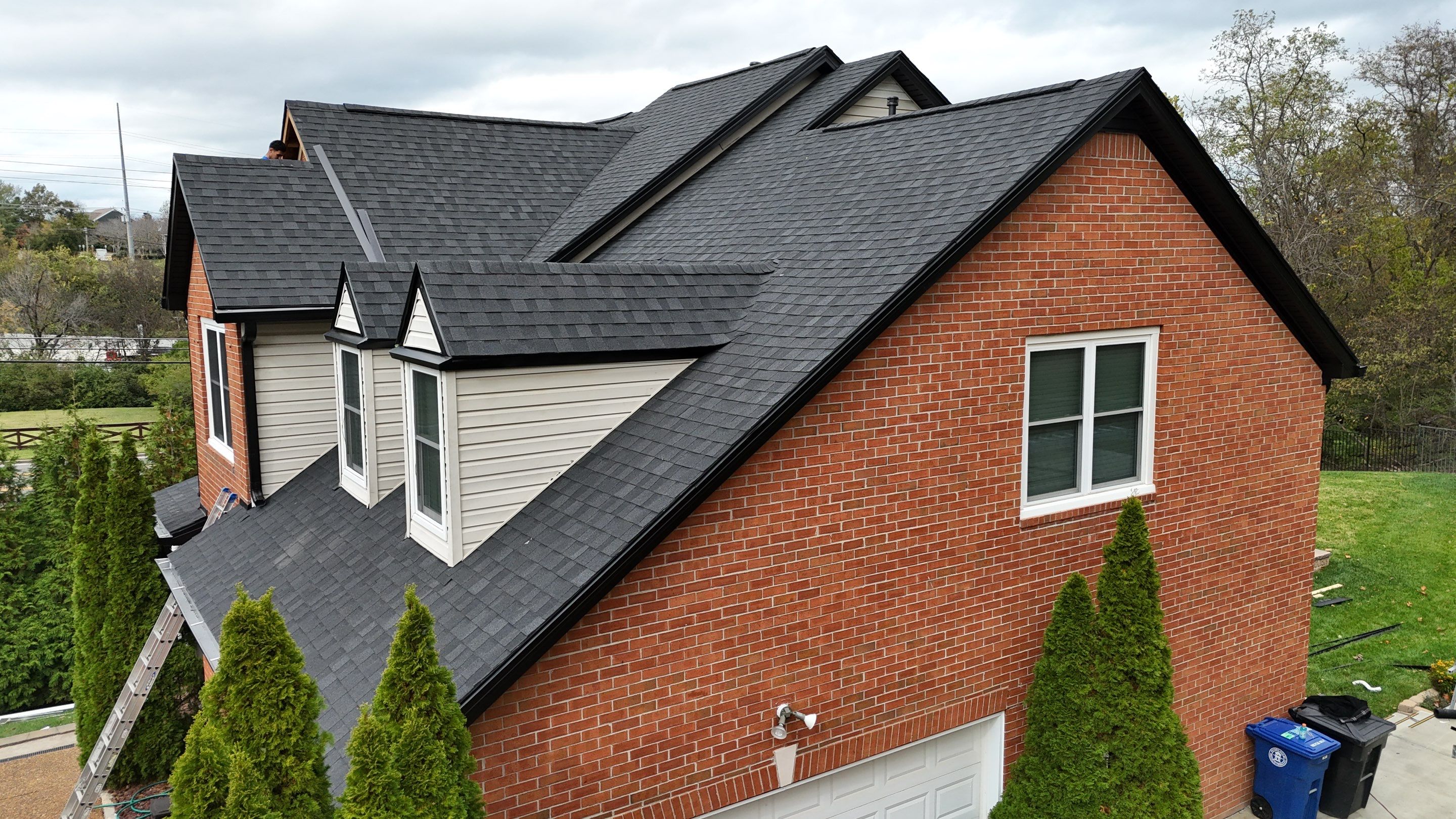 Charcoal Black Re-Roof & Gutters by Royal House LLC
