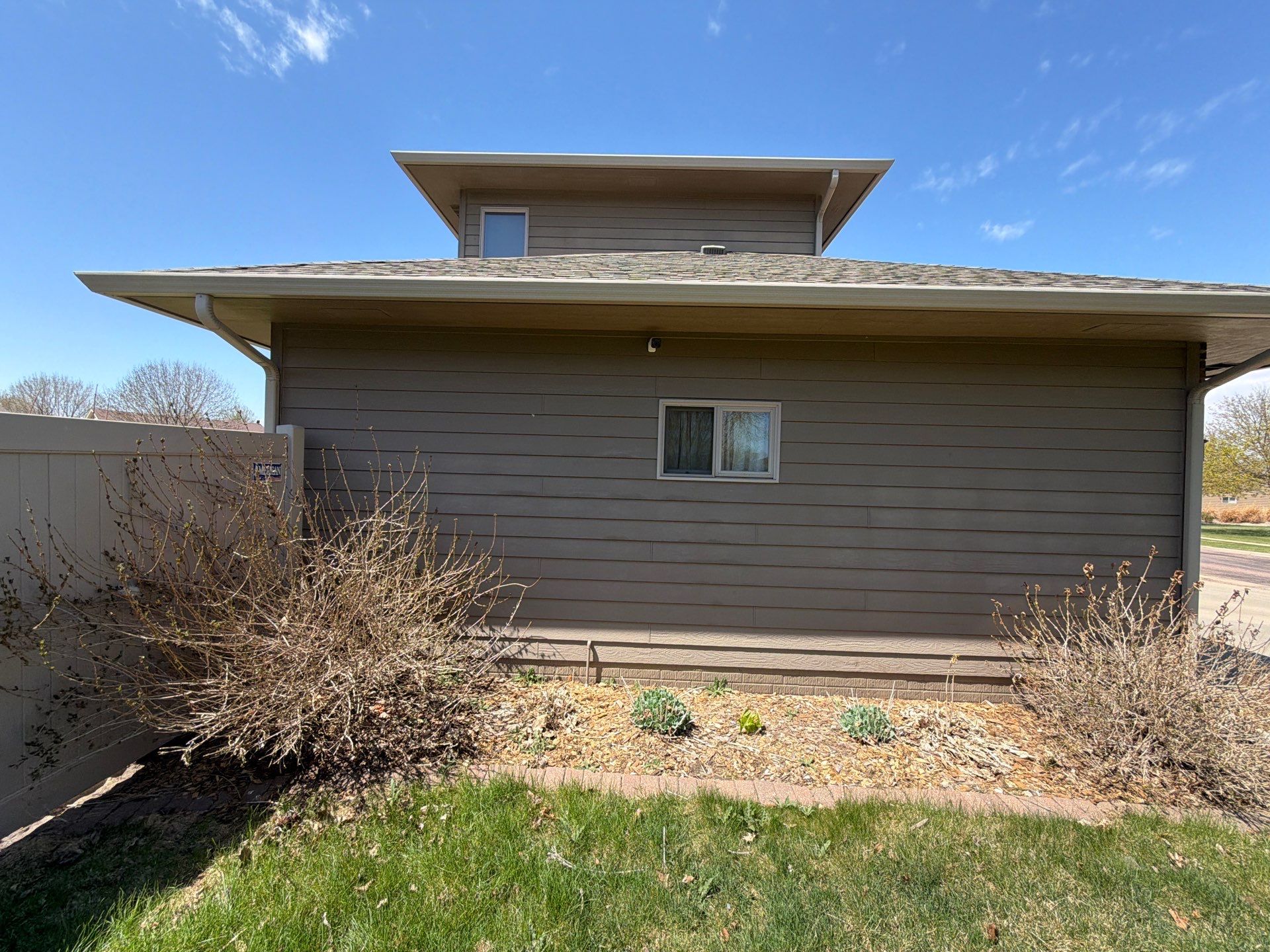 Residential Exterior Painting with Shutter and Trim Updates in Sioux Falls by Select Painting, Coatings & Garage Cabinets
