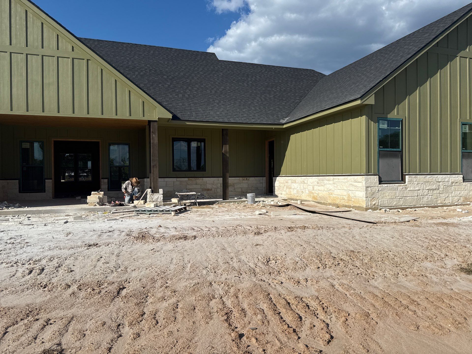 Cleveland Ranch Charm: Natural Stone Wainscot with Green Accent Siding. by Apex Conventional Stucco Llc