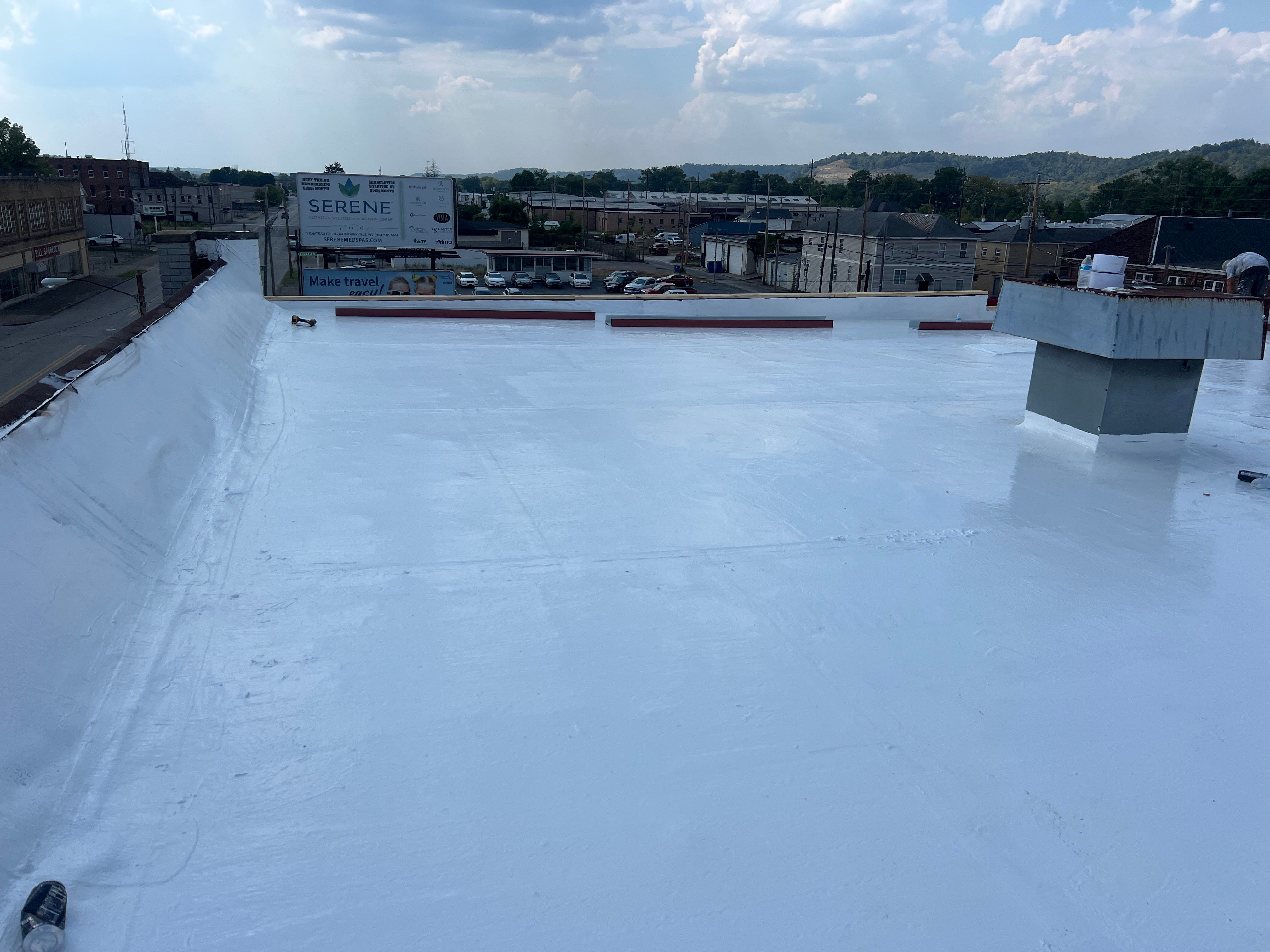 Commercial Roofing Installation using smartcoat Roof coating by Fahey Roofing + Contracting