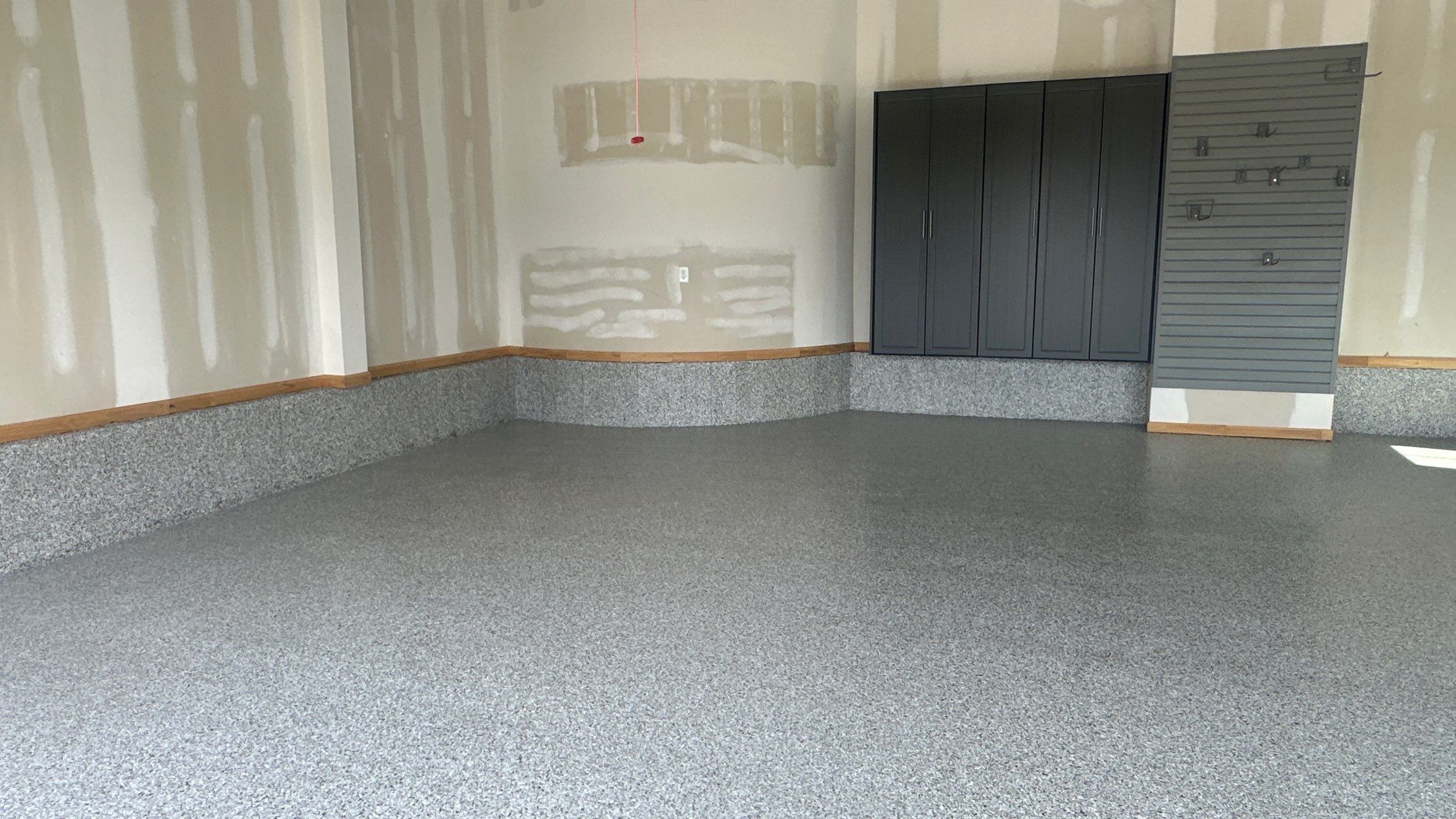 Megan J. added cabinets and slotwall to her garage. Plus a New Floor by Banner Garage