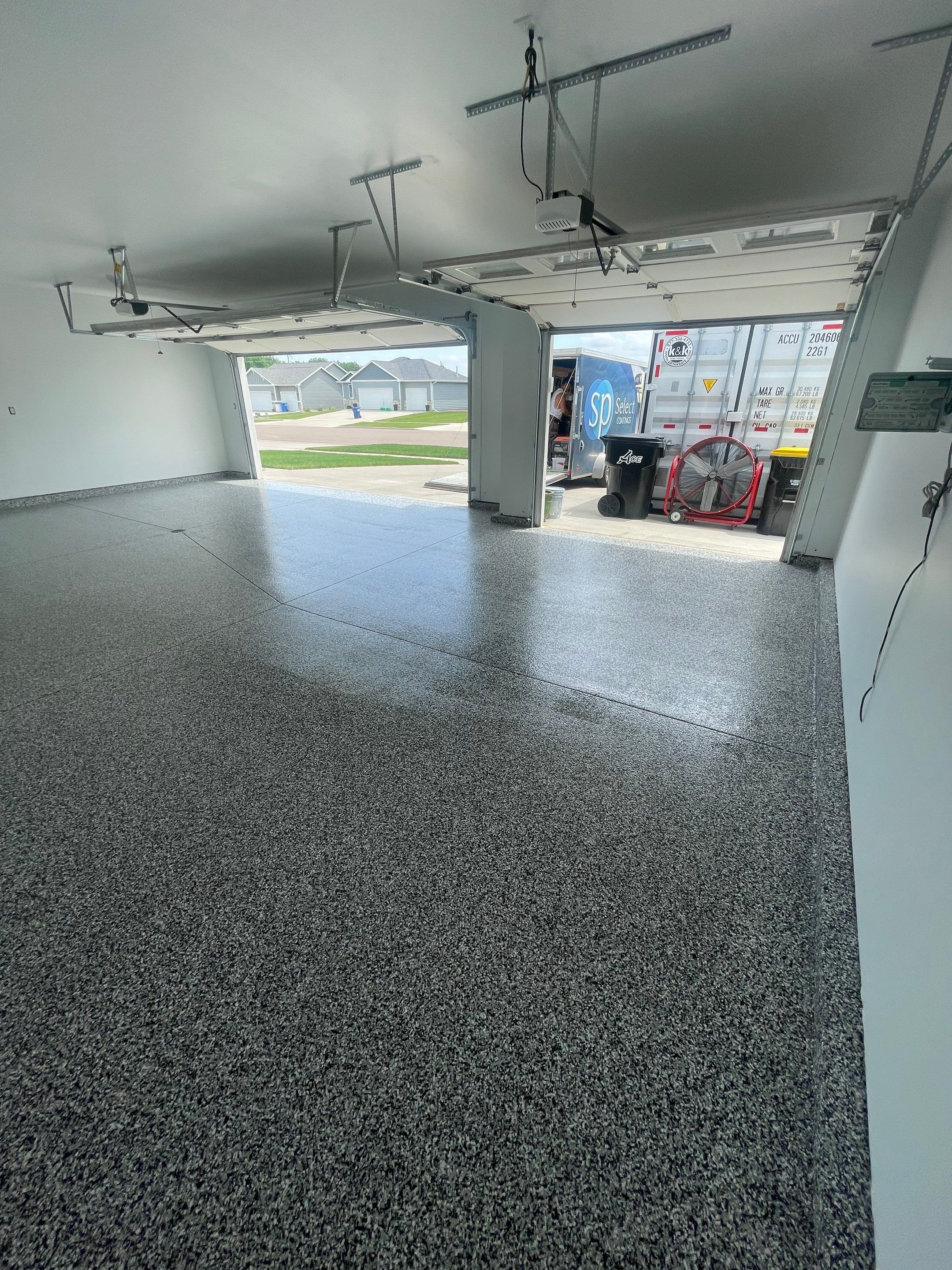 Grey Flake Epoxy Garage Floor Coating in Sioux Falls by Select Painting, Coatings & Garage Cabinets