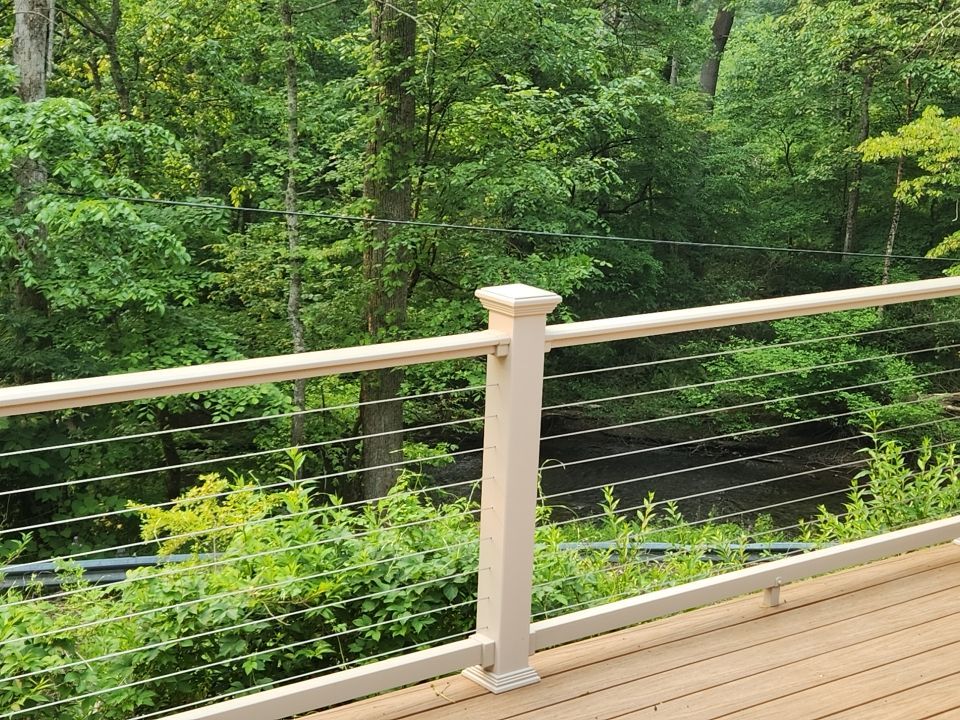 Deck installation using cable railing. by Burke Home Services