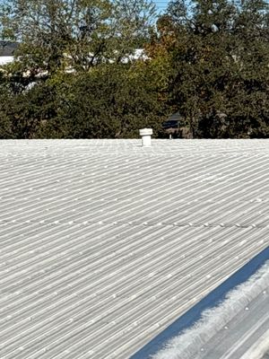 Metal roof surface with small vent pipe