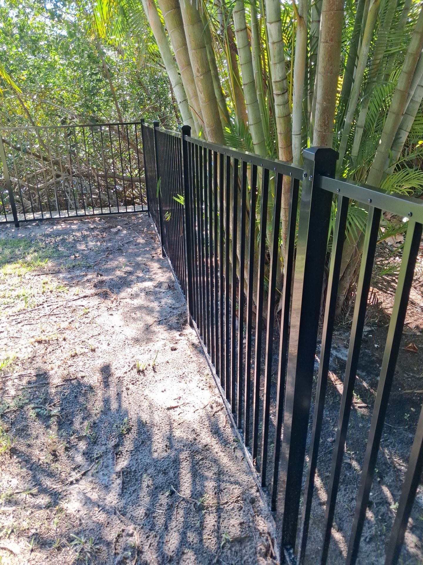 Black Aluminum Picket Fence Installation for Port Charlotte Canal Home by True Fence LLC