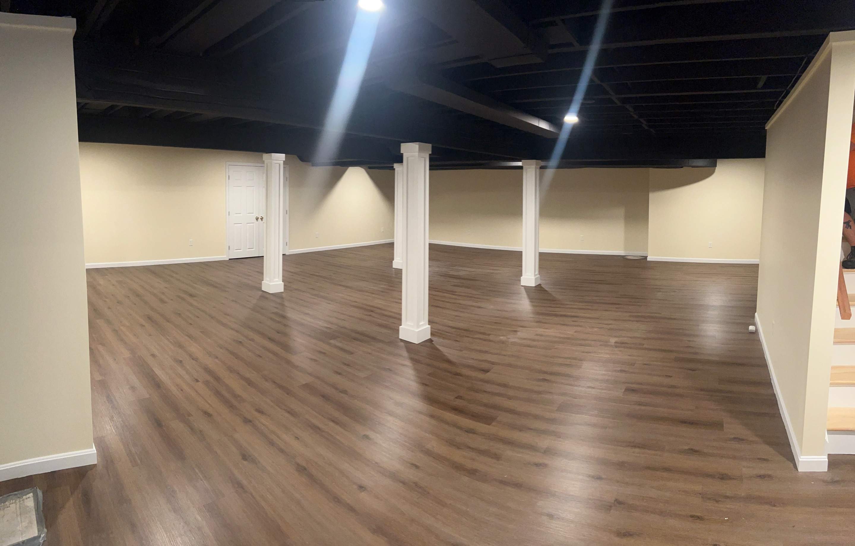 Basement Remodel w/ LVP Flooring & Exposed Ceiling by Chagnon Building & Remodeling LLC
