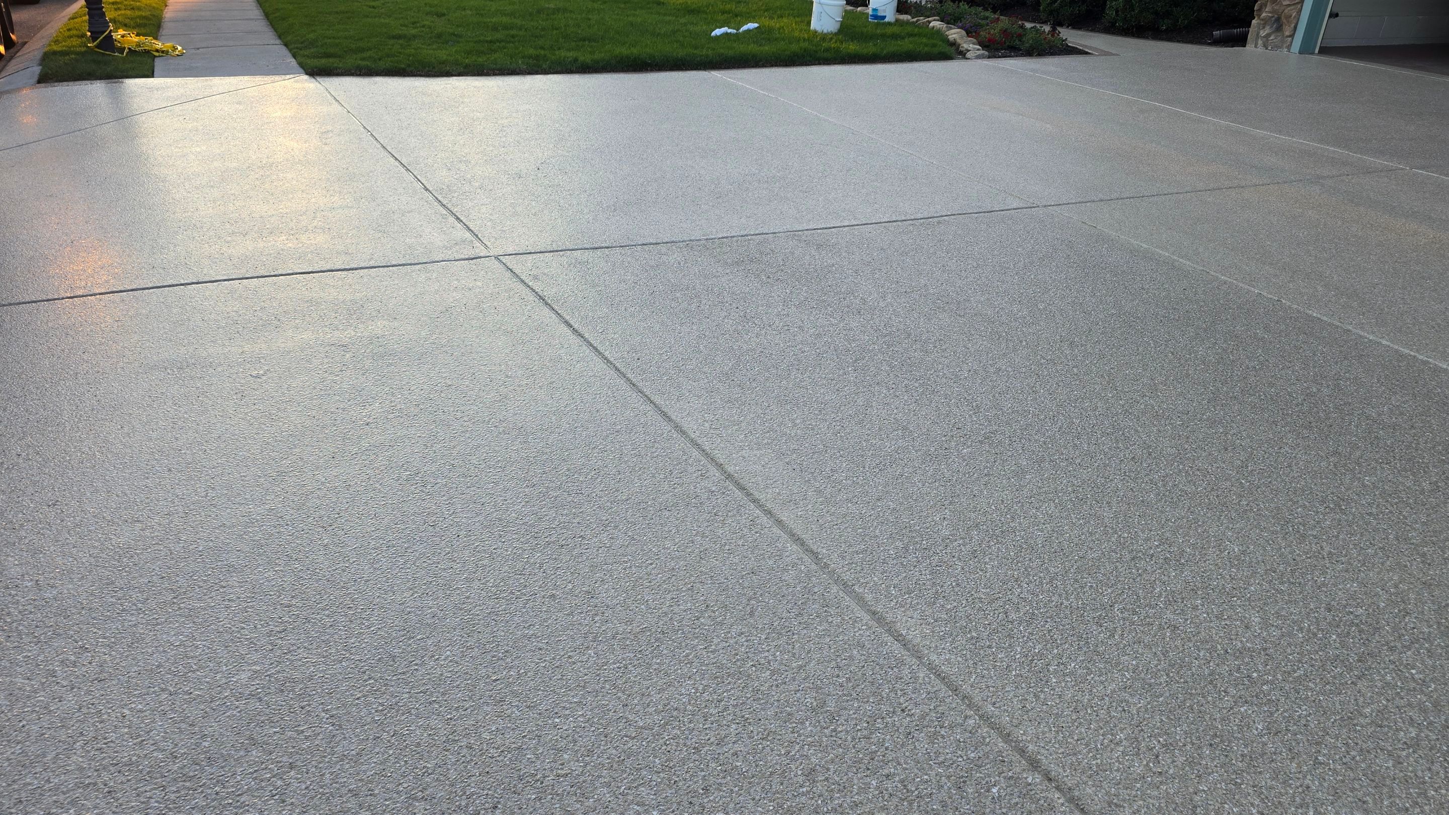 Driveway and sidewalk using Feldspar with the border done in Spilite by Elite Floor Solutions