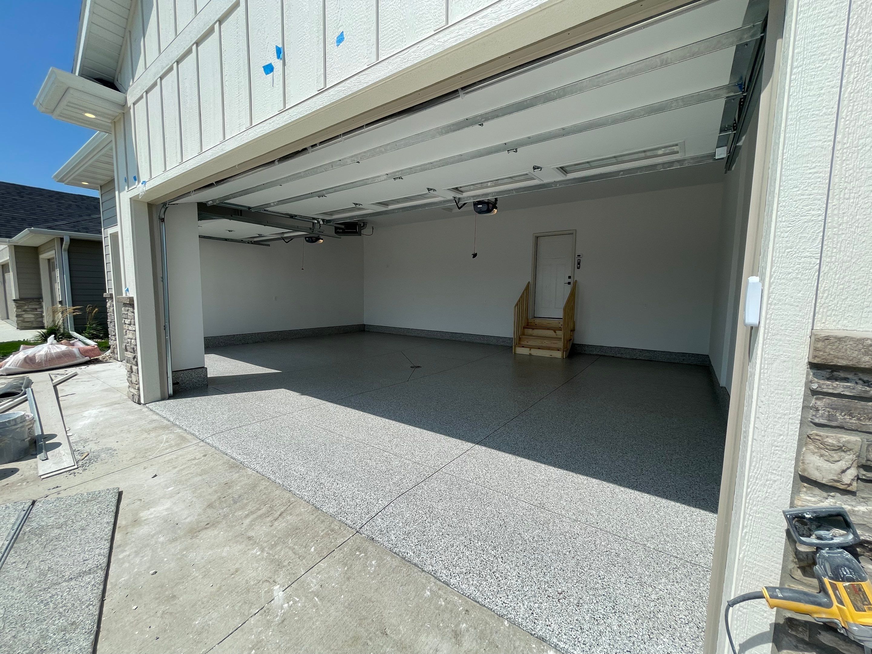 Grey Speckled Garage Floor Coating in Sioux Falls by Select Painting, Coatings & Garage Cabinets